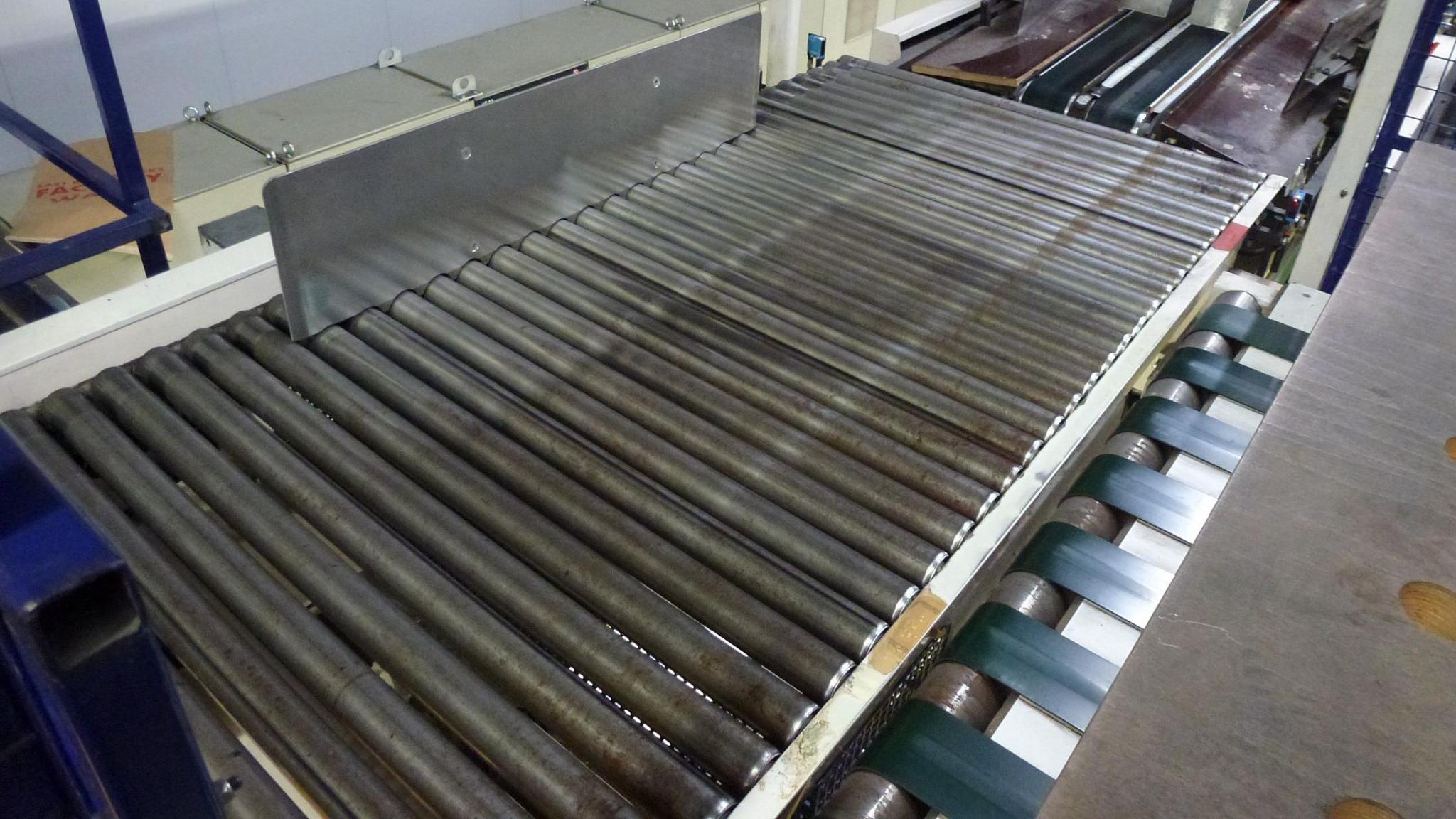 Close-up of a machine with metal rollers.
