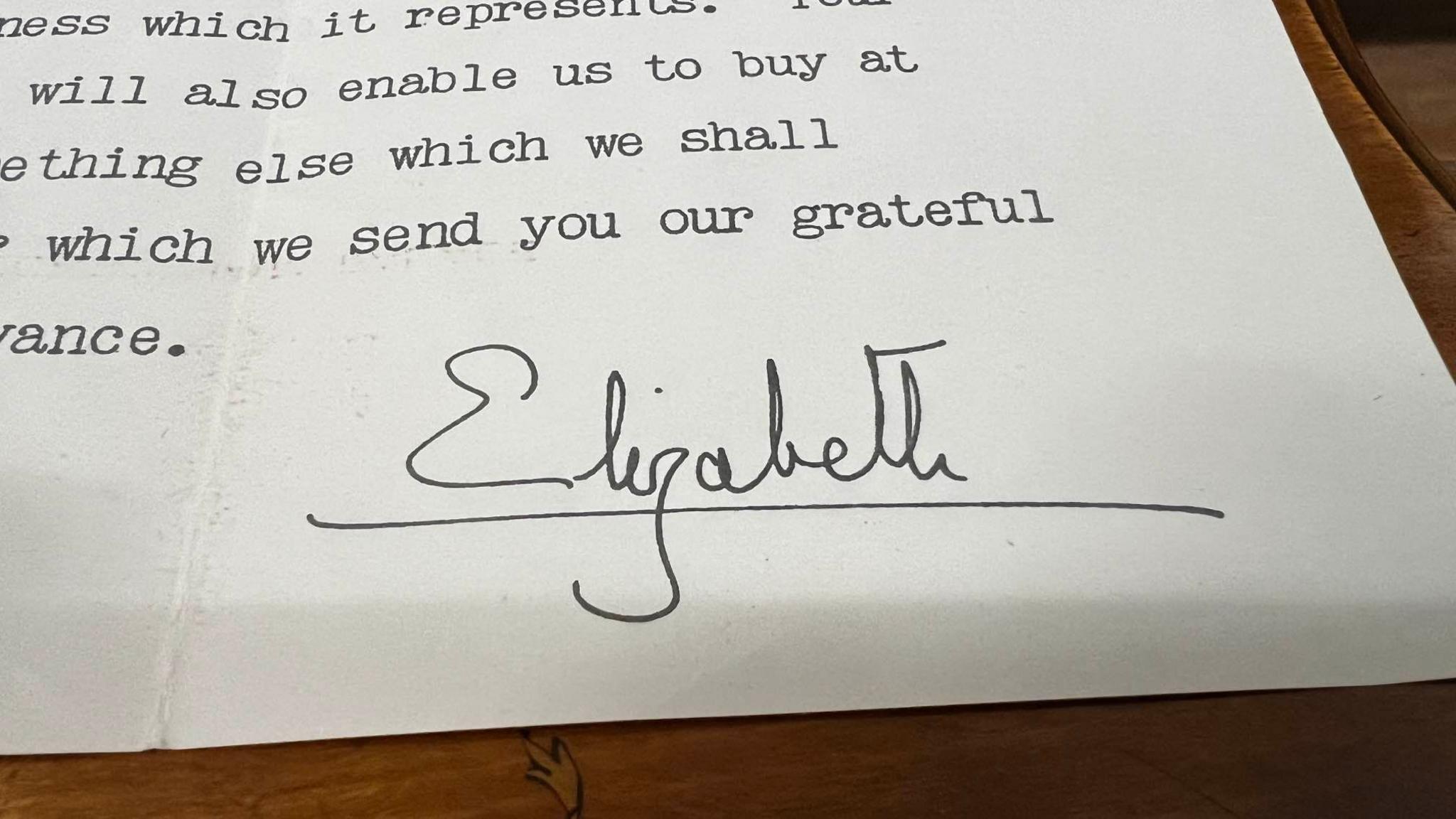 The bottom of the letter from the Queen, which is signed off in her signature that reads "Elizabeth". It has been written in black pen. Above the signature are words typed out.