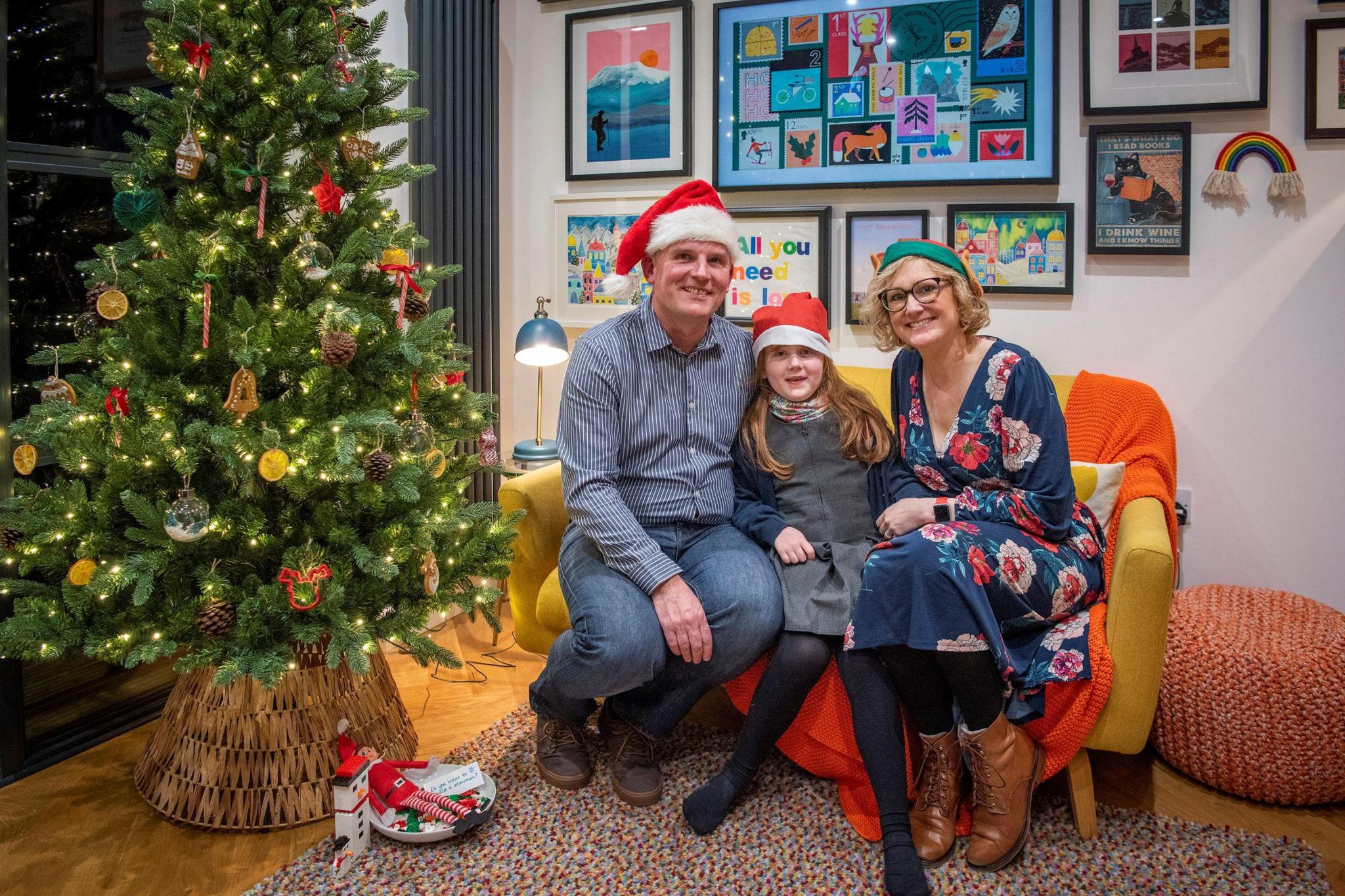 The family sitting on a sofa