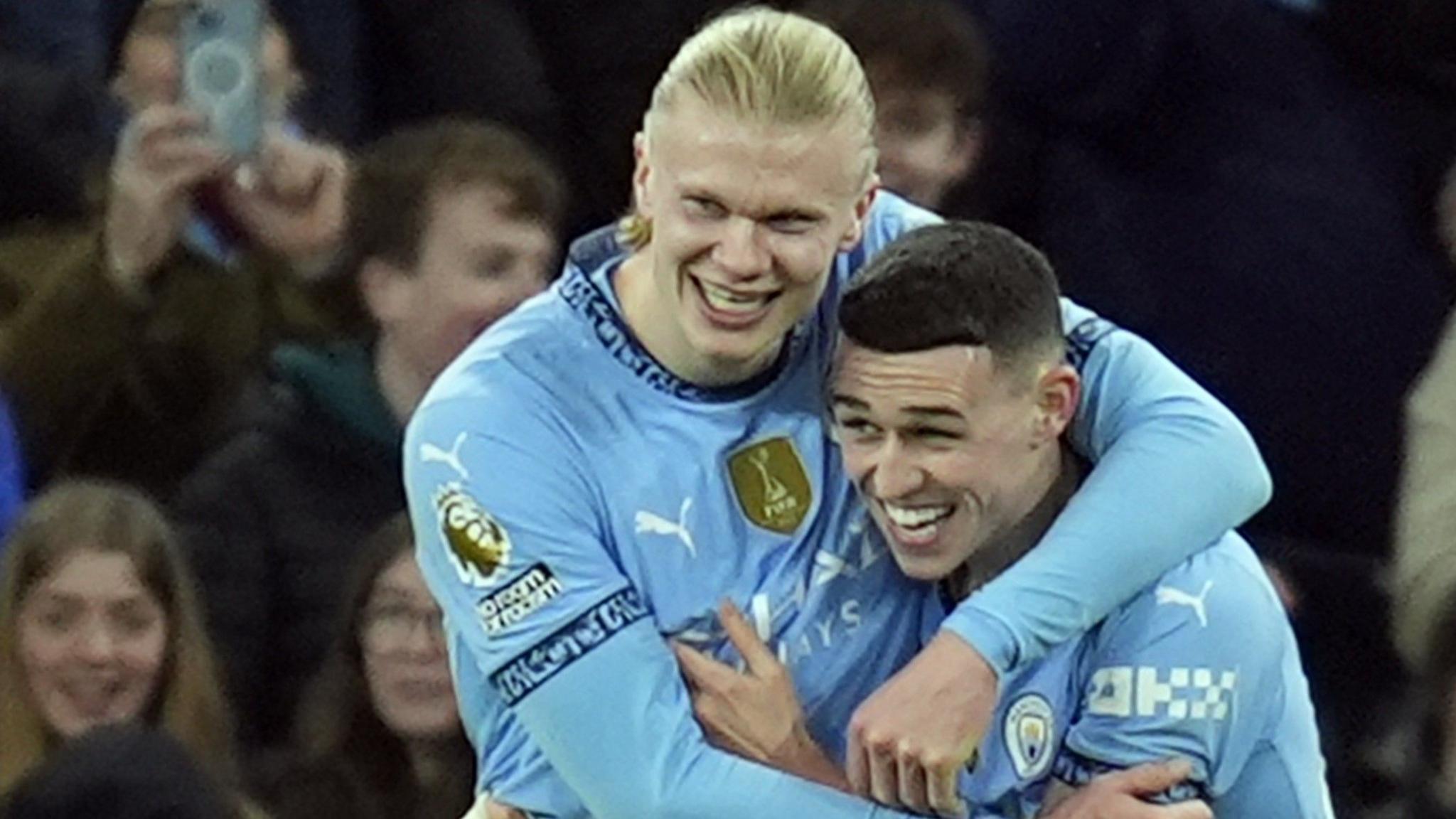 Erling Haaland and Phil Foden hug in celebration