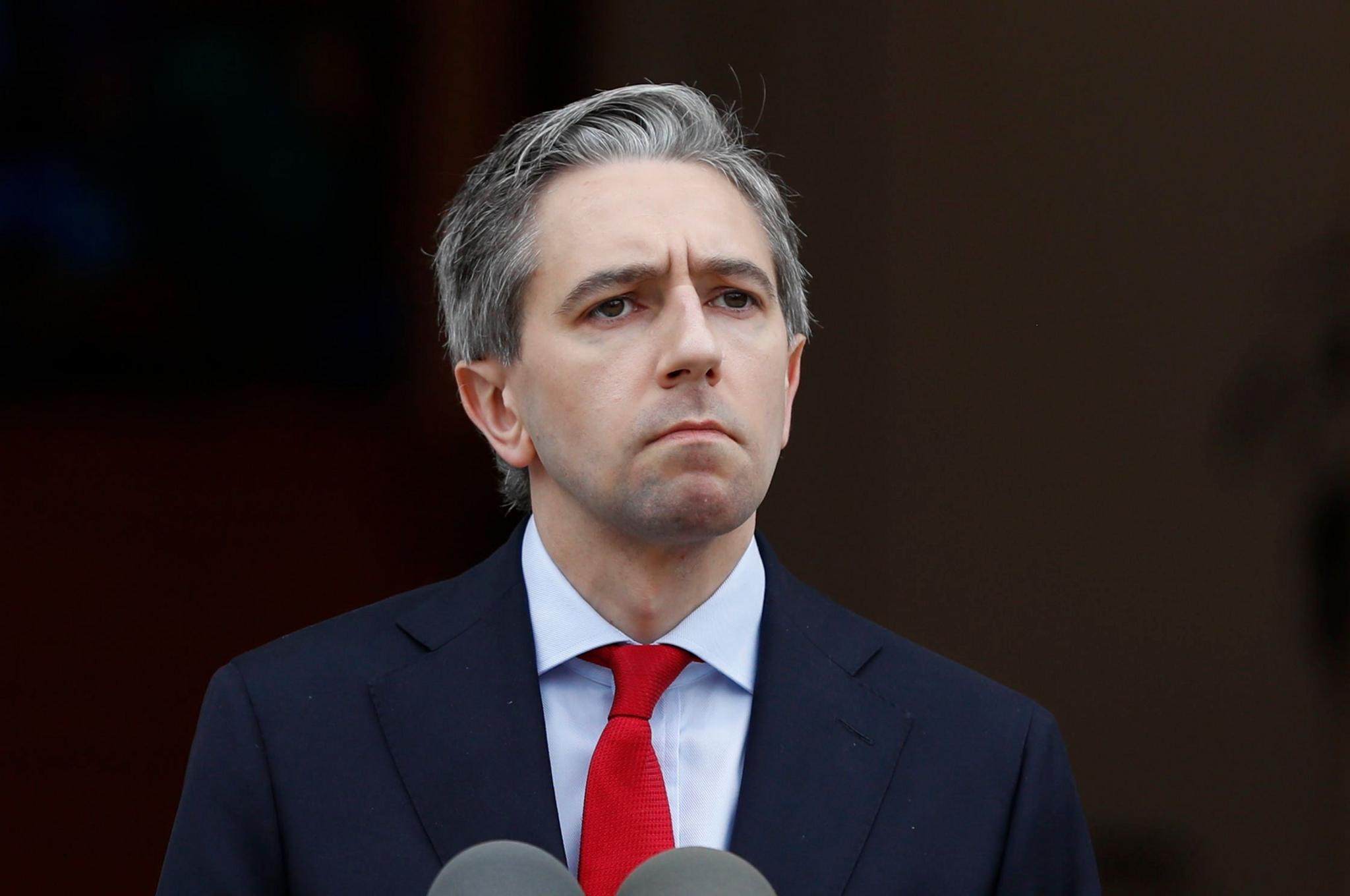 Simon Harris in a blyue suit and red tie