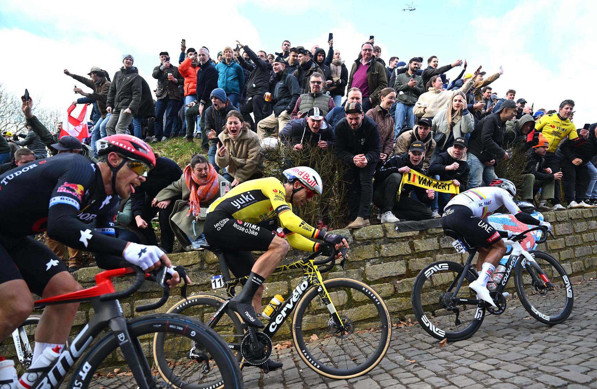 Team Vismas  Wout van Aert of Belgium competes climbing the Muur van Geraardsbergen while fans cheer during the 80th Omloop Het Nieuwsblad 2025 - Men's Elite a 197km one day race from Ghent to Ninove, Belgium.