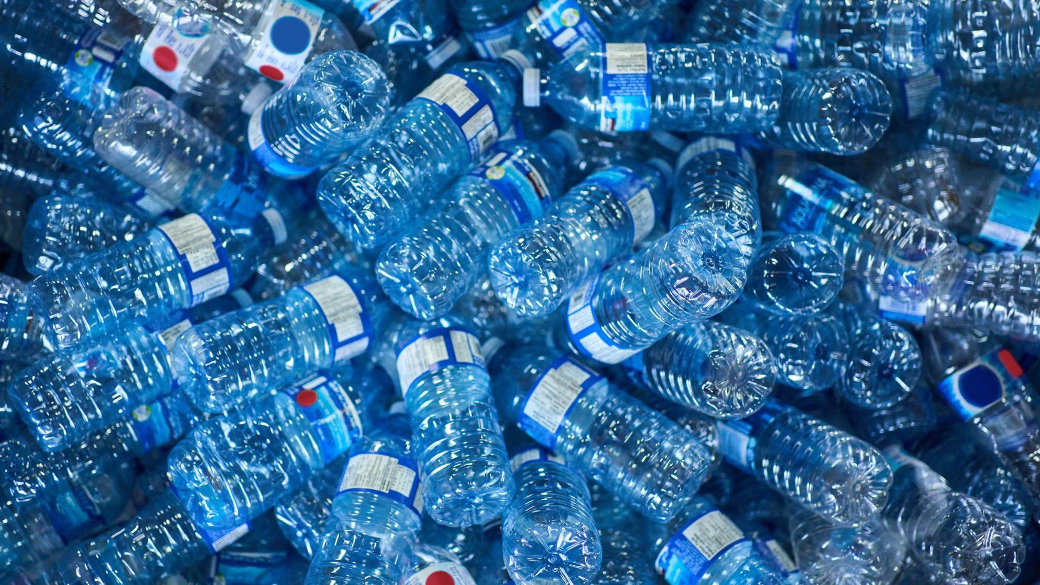 A close-up of loads of blue plastic bottles.