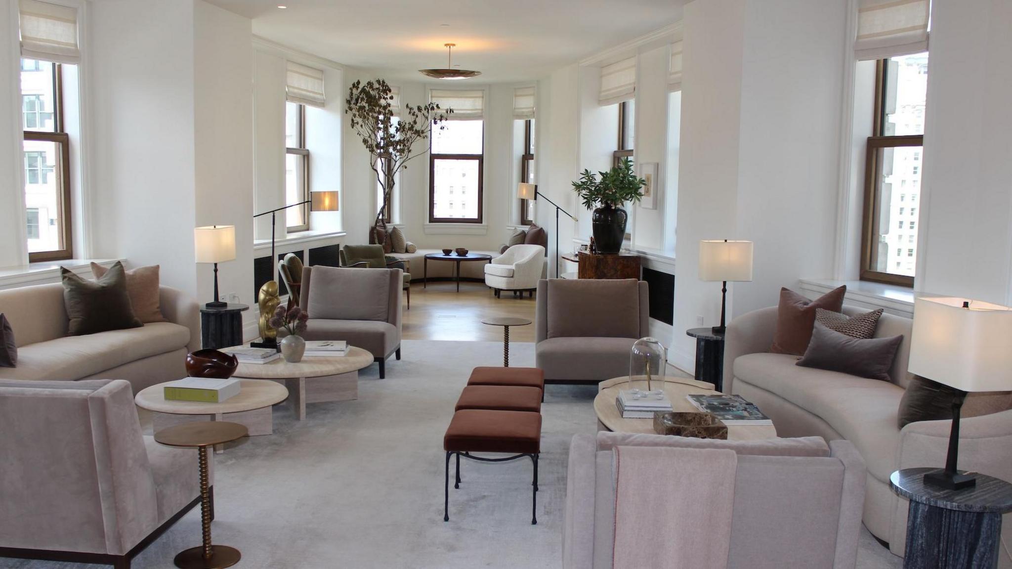 View of triangular shaped apartment living room, with modern furniture, high ceiling, and windows all around