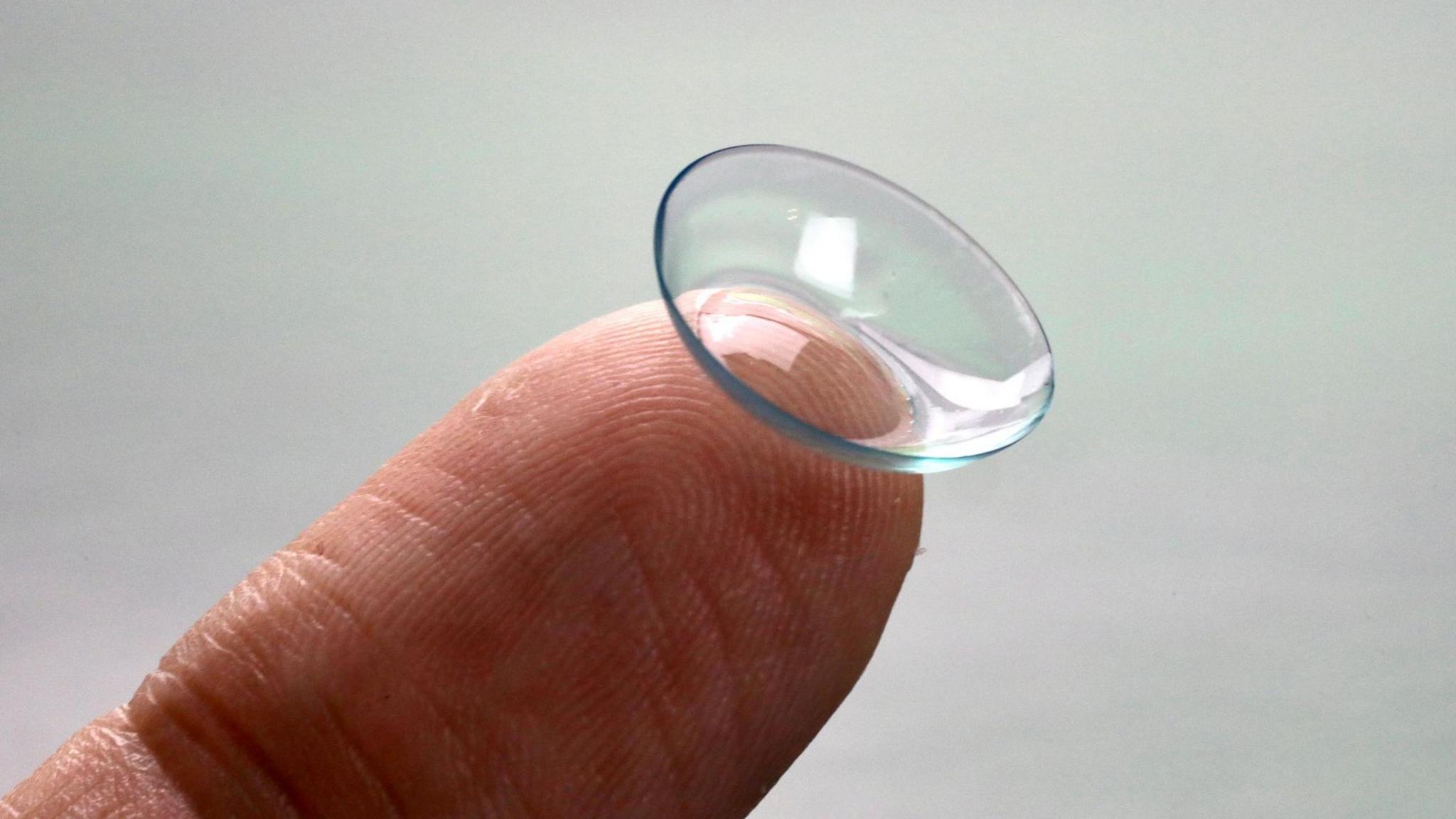a contact lens on a finger