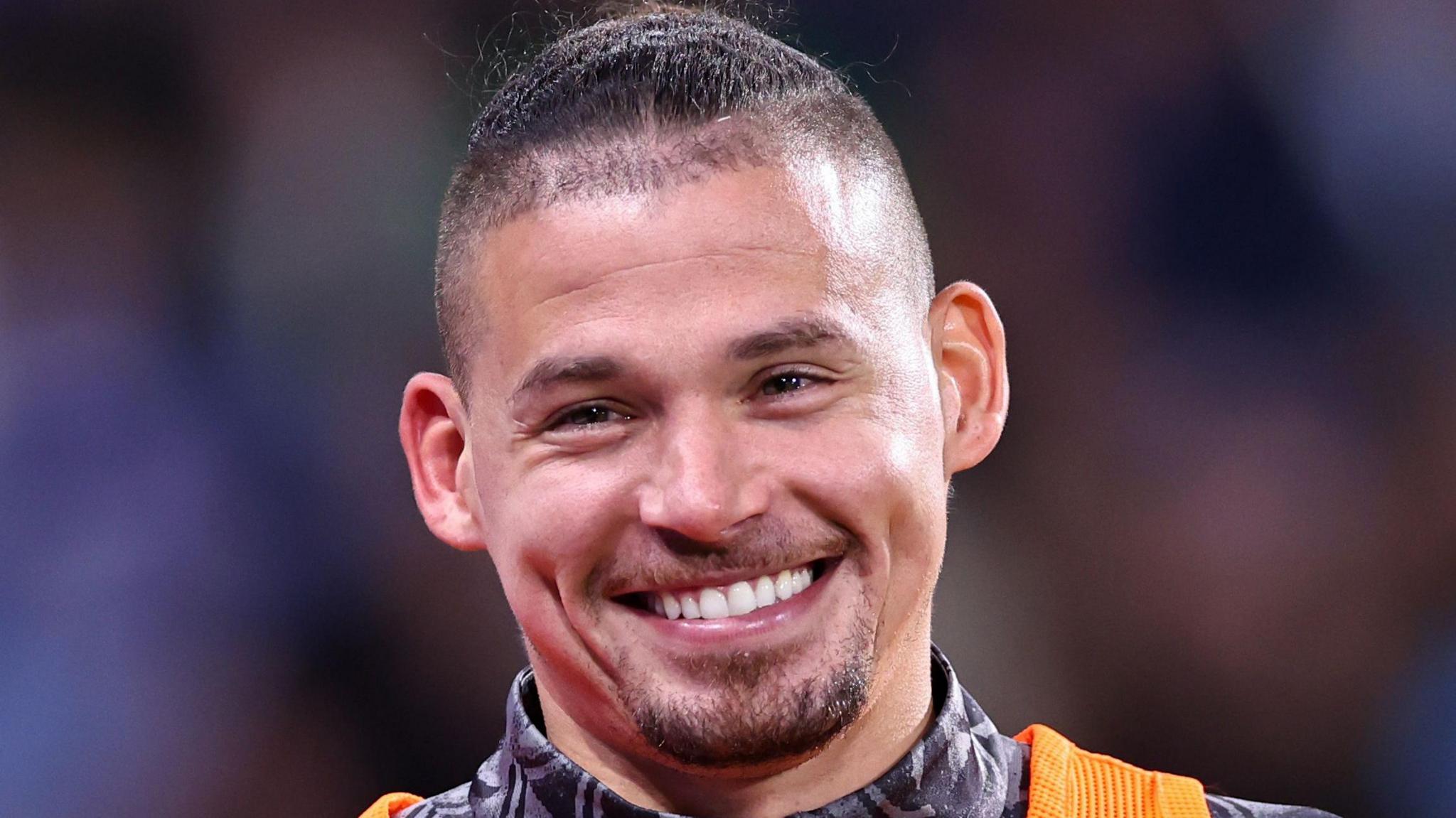 Kalvin Phillips smiling while warming up for Manchester City