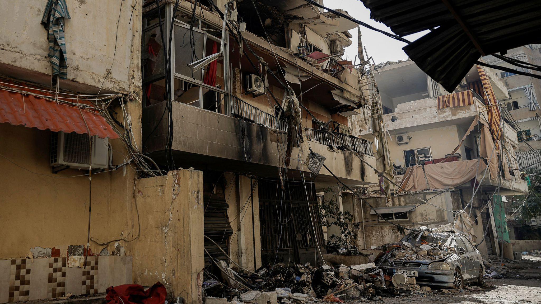 A damaged vehicle lies amid  rubble after an air strike in the Chiyah area of Dahieh. 