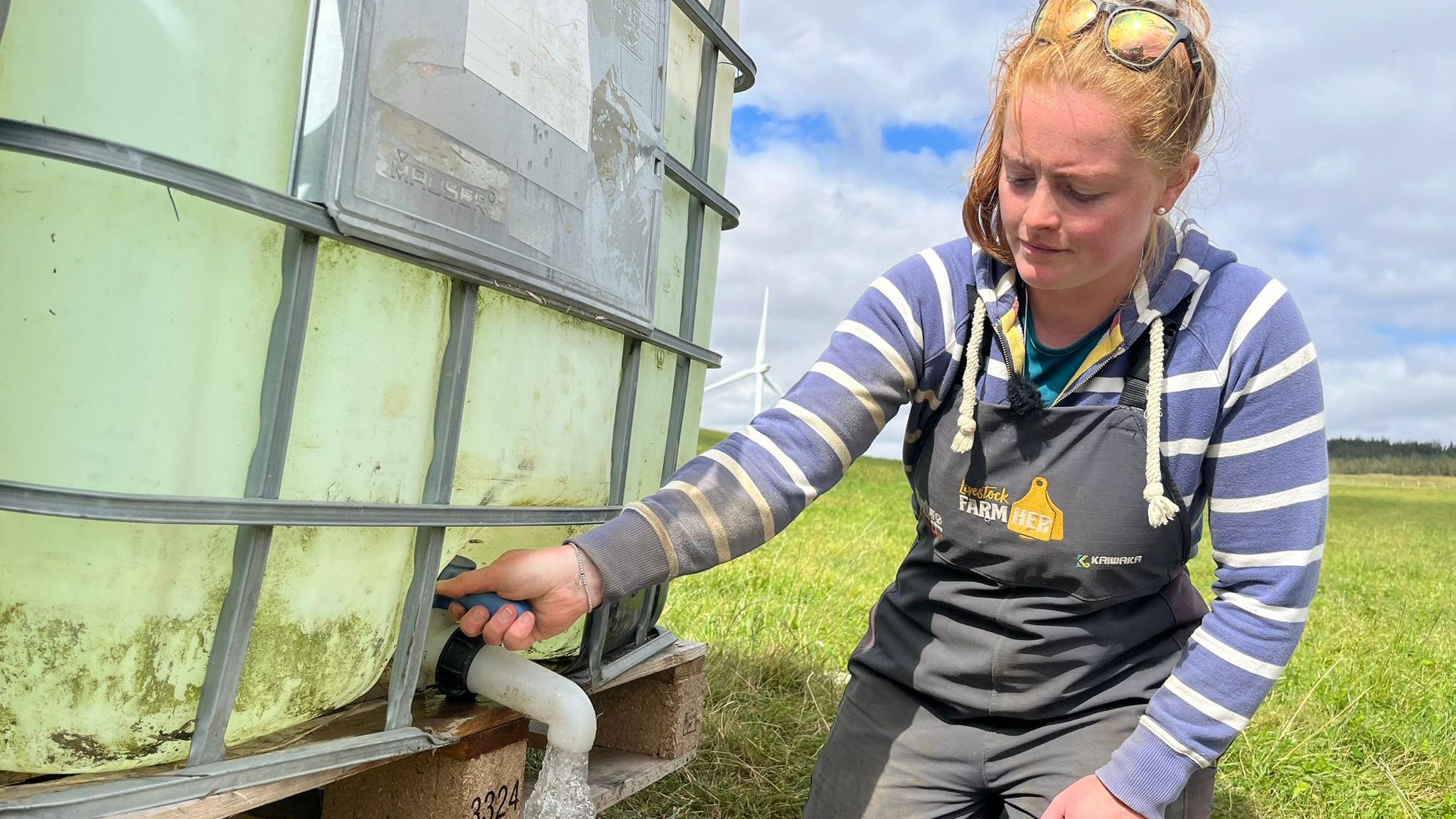 Nicola Wordie letting water out of the tank
