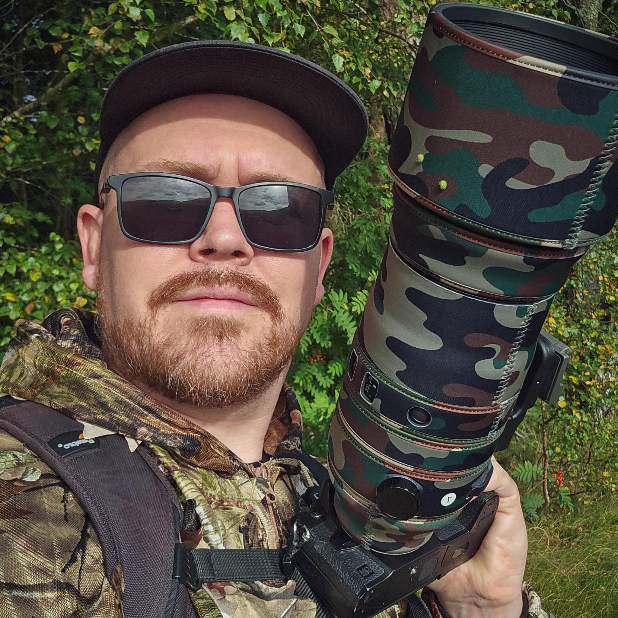 Jimmy Reid wears camouflage gear to take pictures of owls