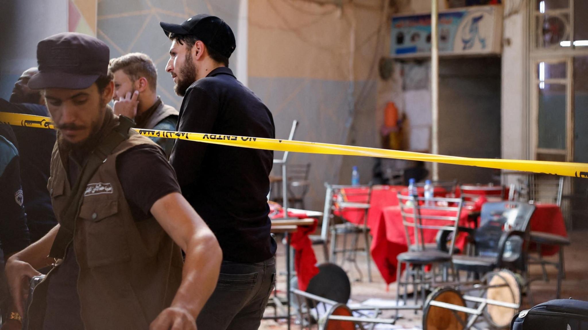 Syrian emergency services personnel work at the site a bomb blast at a cafe in central Damascus, Syria (2 July 2026)