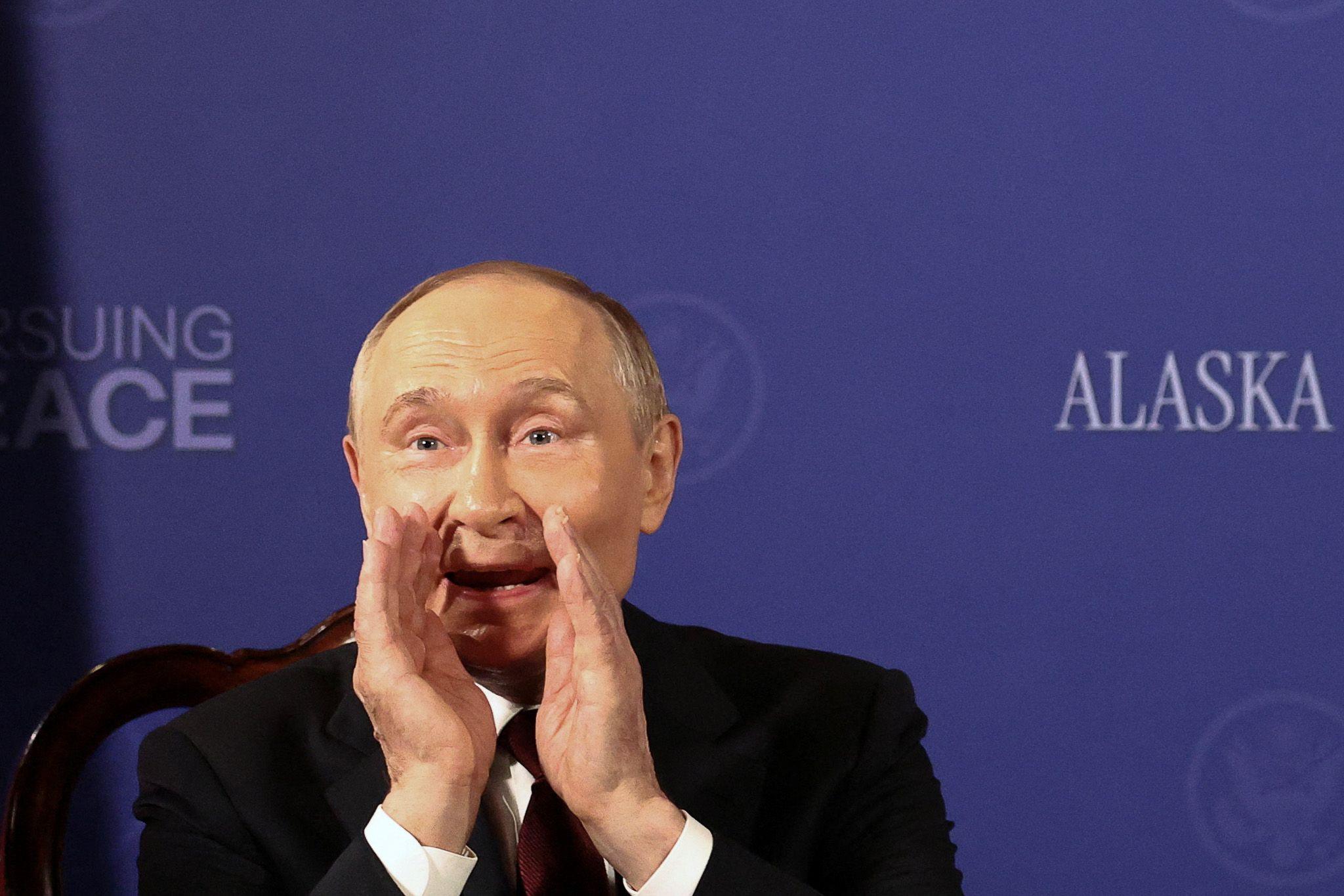 Putin gestures to reporters after being asked, "Will you you stop killing civilians?"