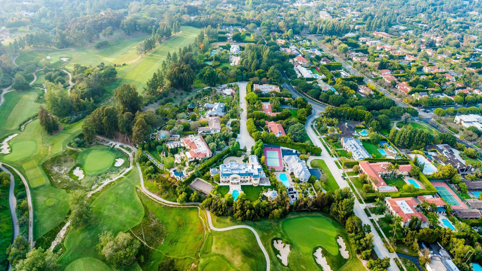 Aerial view of Bel-Air neighbourhood, showing big houses, lots of swimming pools, and a big golf course.