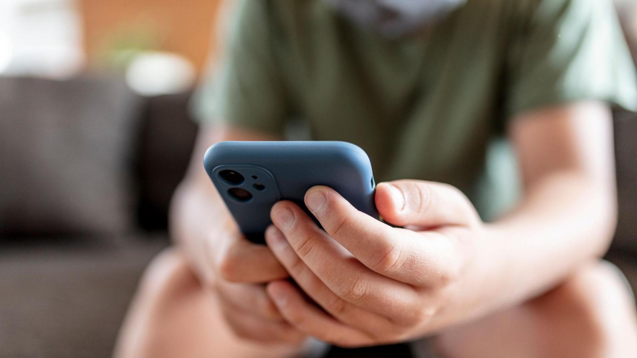 Boy using smartphone.