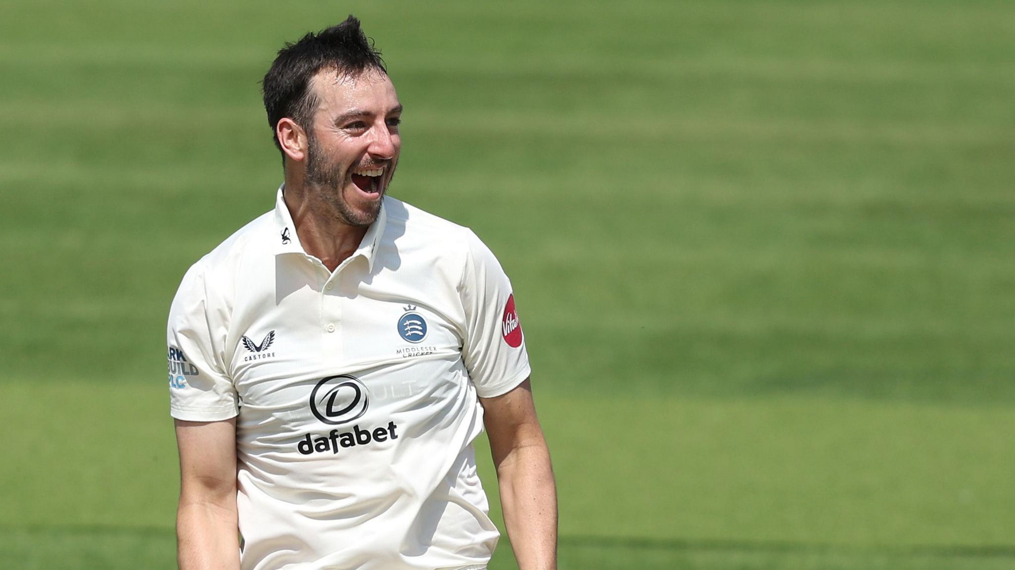 Toby Roland-Jones, of Middlesex, celebrates taking a wicket