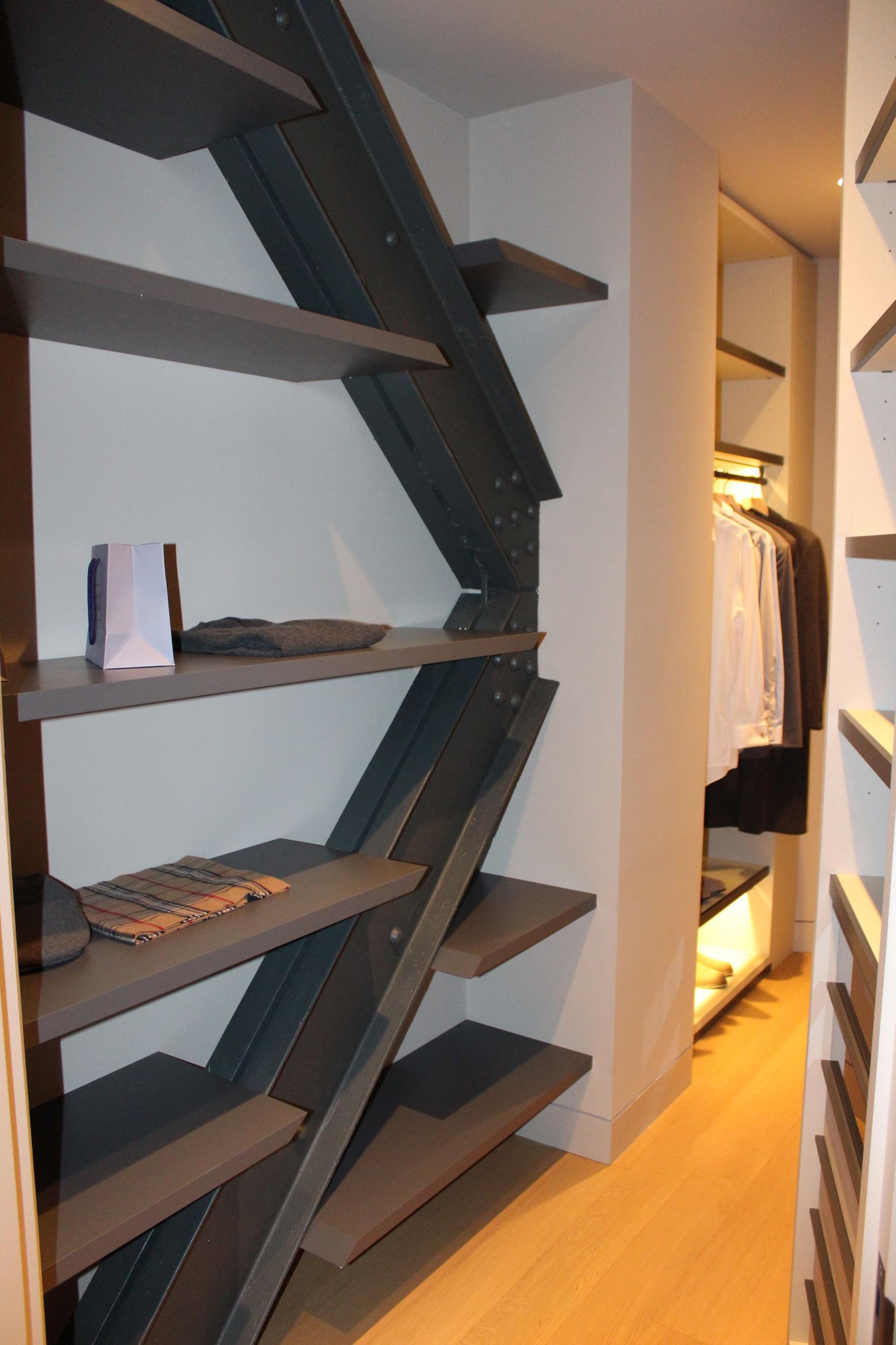 Zig-zagging steel beams with shelves built into them in a walk-in closet