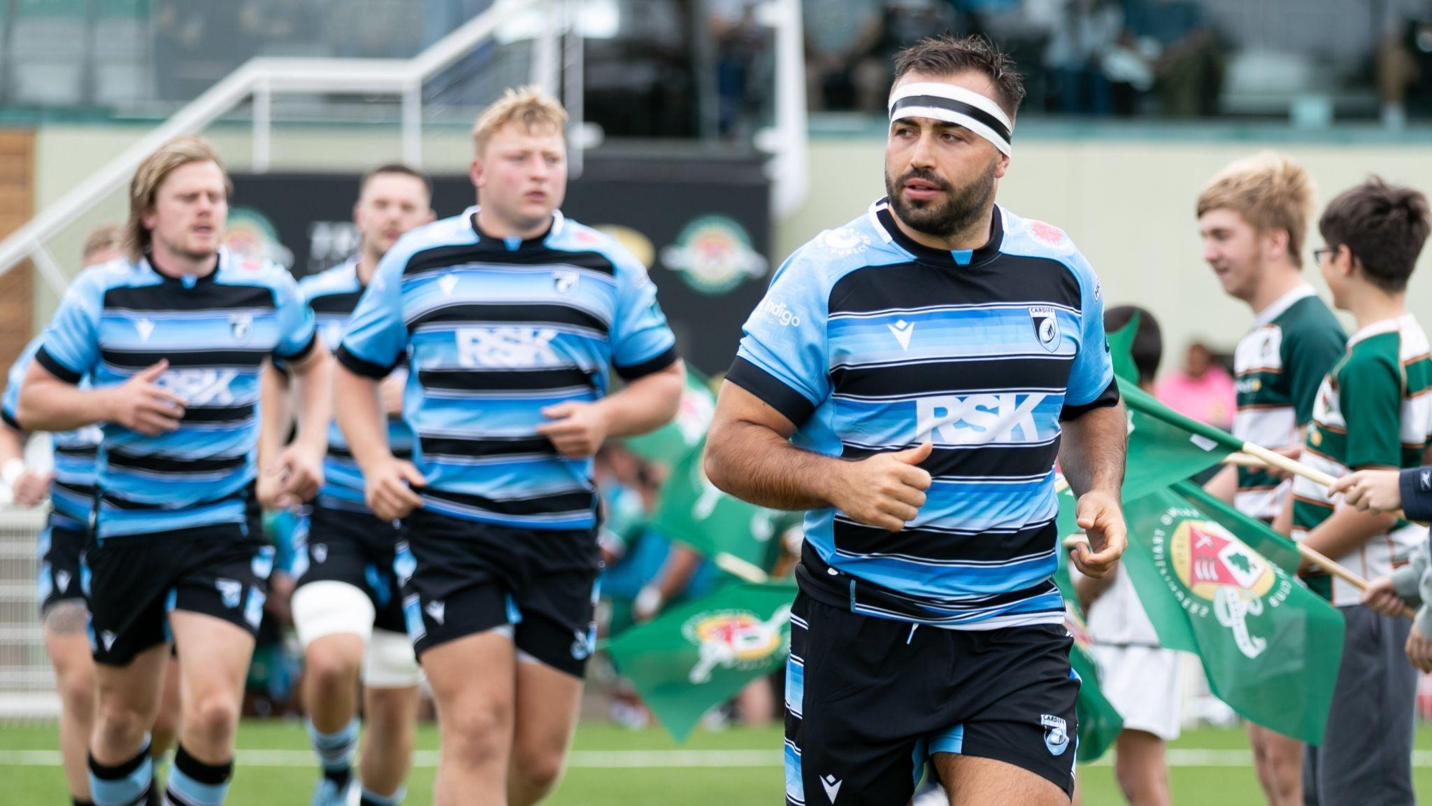 Liam Belcher of Cardiff Rugby leads his team as they run out prior to a pre-season game at Ealing Trailfinders