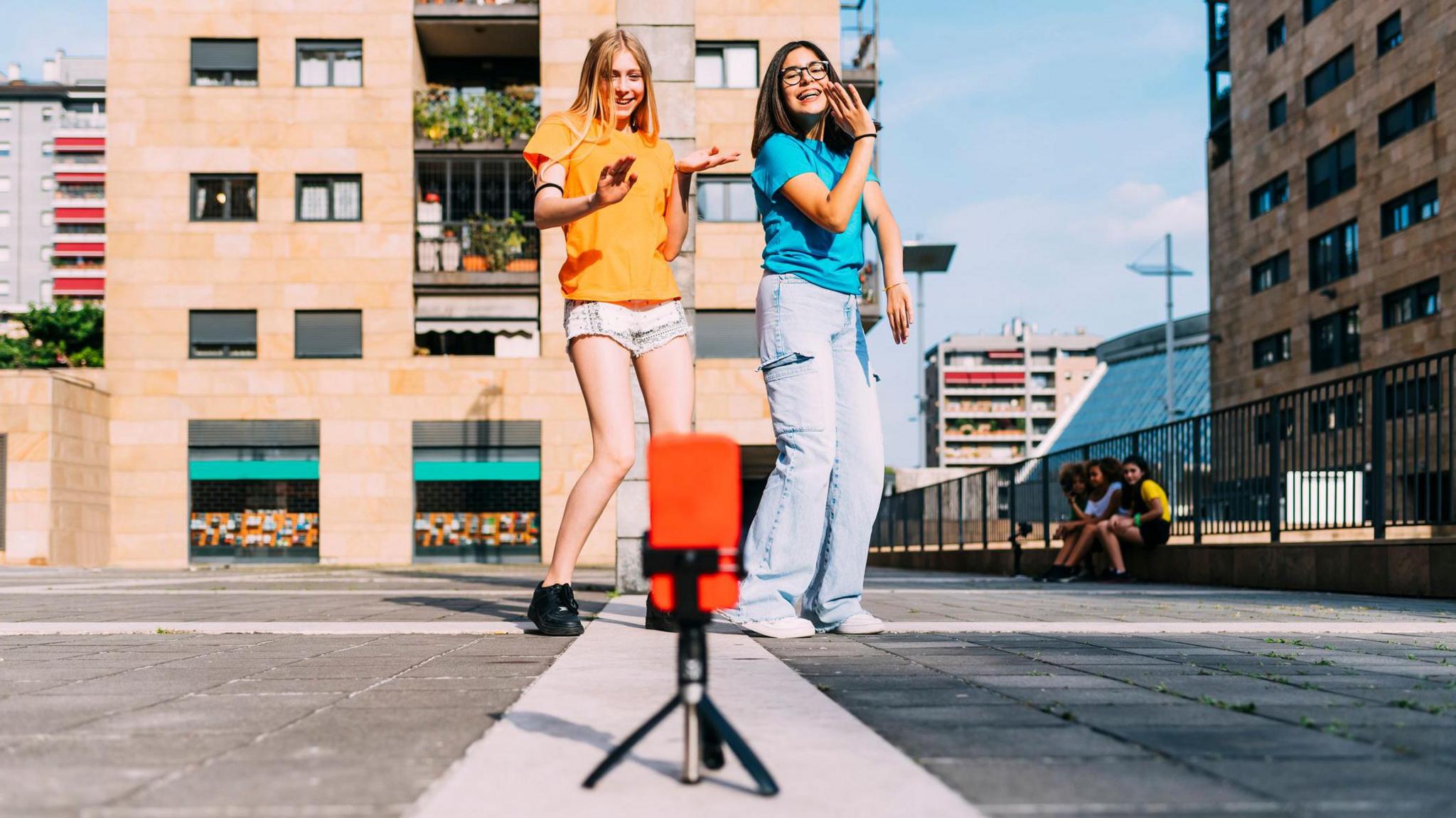 Girls filming themselves dancing in the street 