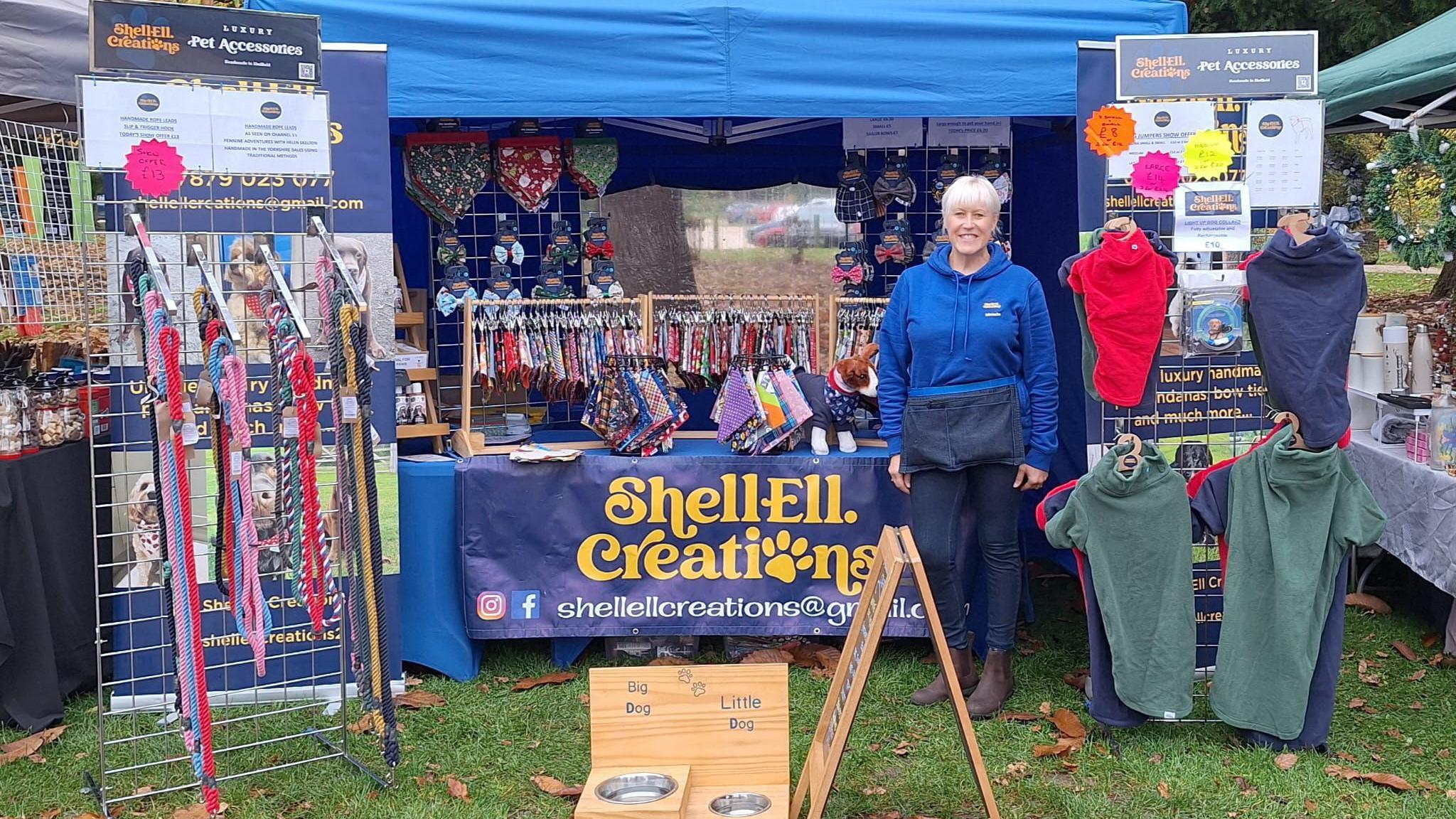 Michelle Elliott stood beside her stall which sells brightly colour pet accessories including jumpers and leads