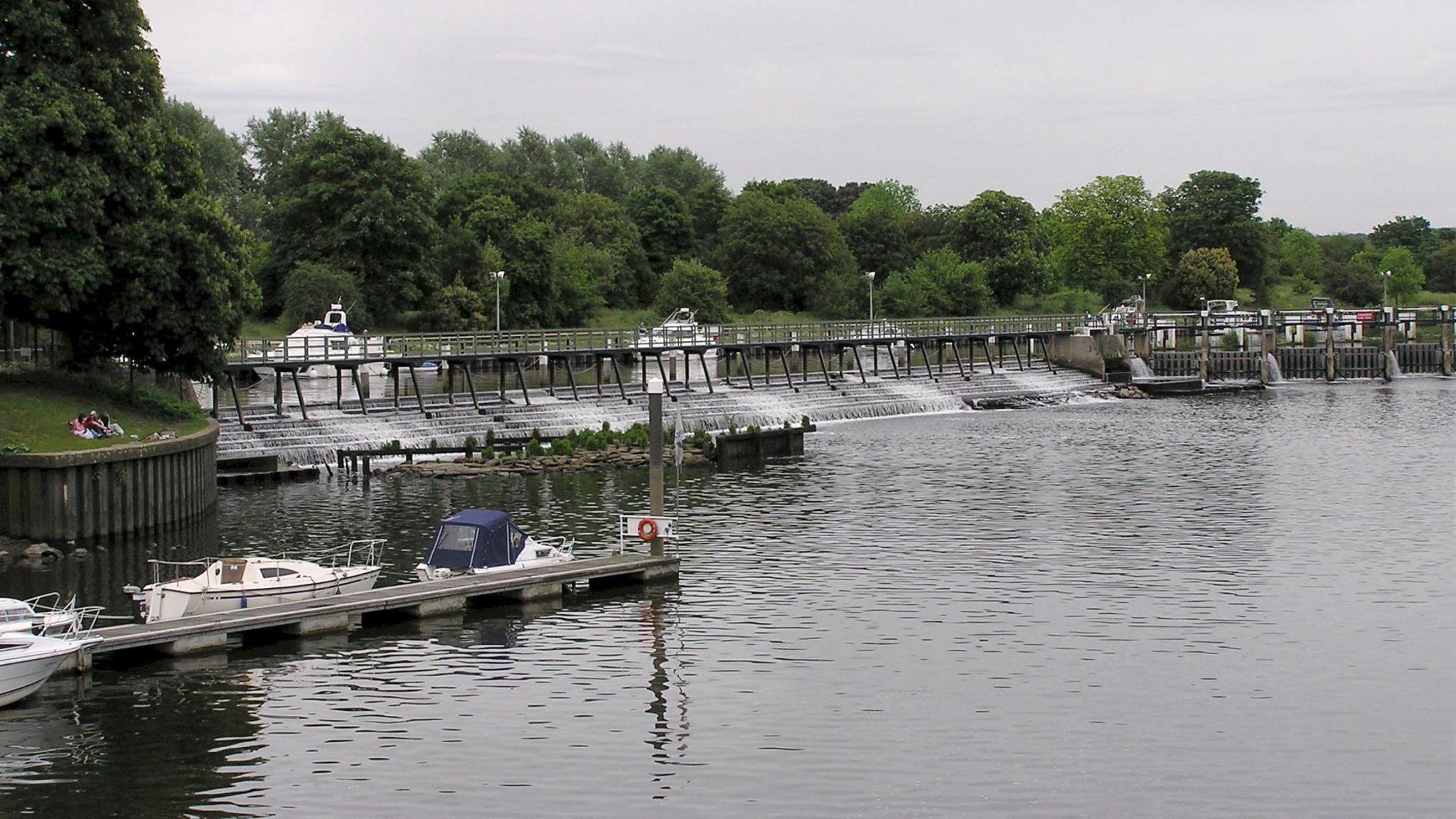 Wide shot Teddington Lock with boats and pontoon in the foreground