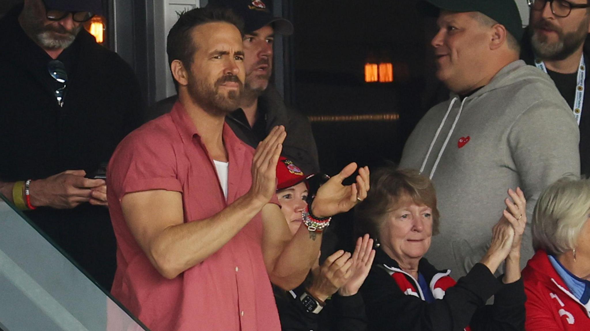 Ryan Reynolds applauding in the stands during a Wrexham game