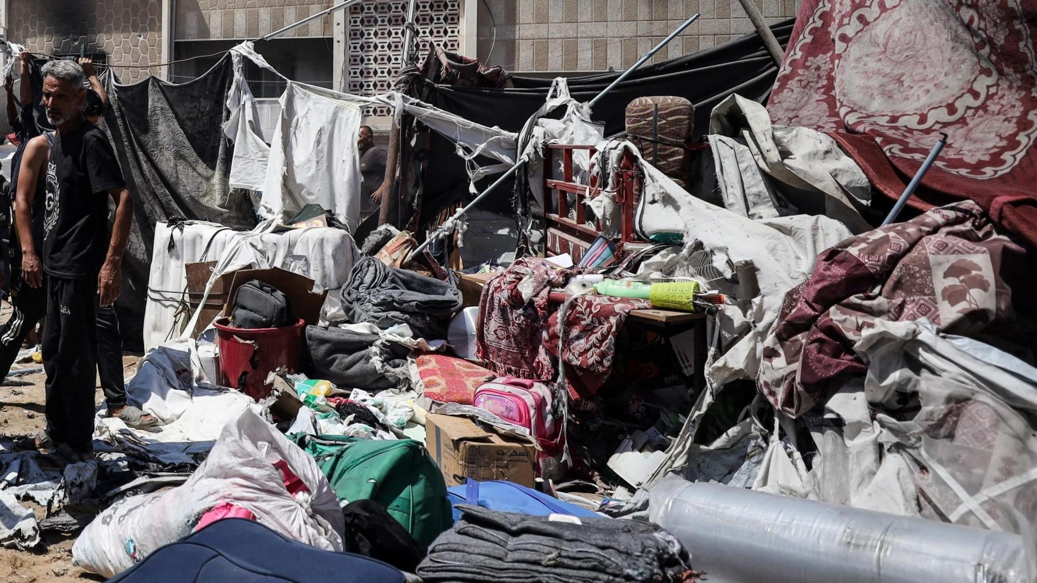 Palestinians inspect the remains of a tent destroyed by an Israeli strike in western Gaza City, near al-Shifa hospital (4 September 2025)