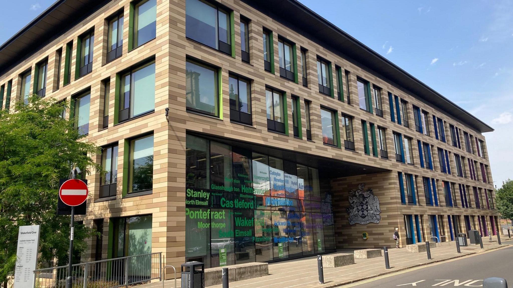 Wakefield Council's headquarters building, Wakefield One, which is a modern brick building with a large glass entrance.