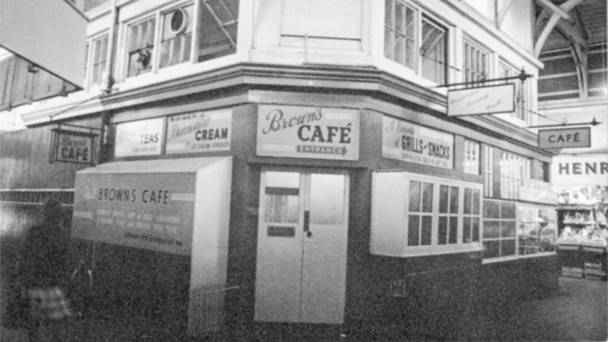 The front façade of Brown's in 1976. It is a small cafe with clear signage and under a covered roof.