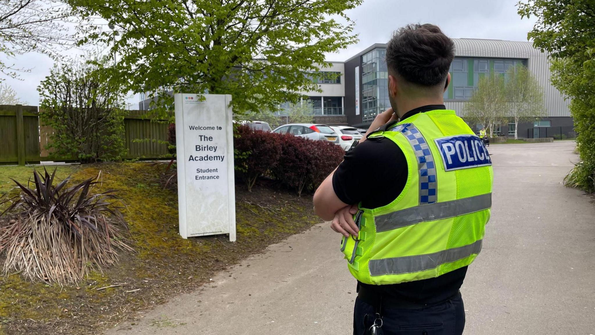 A police officer outside a school