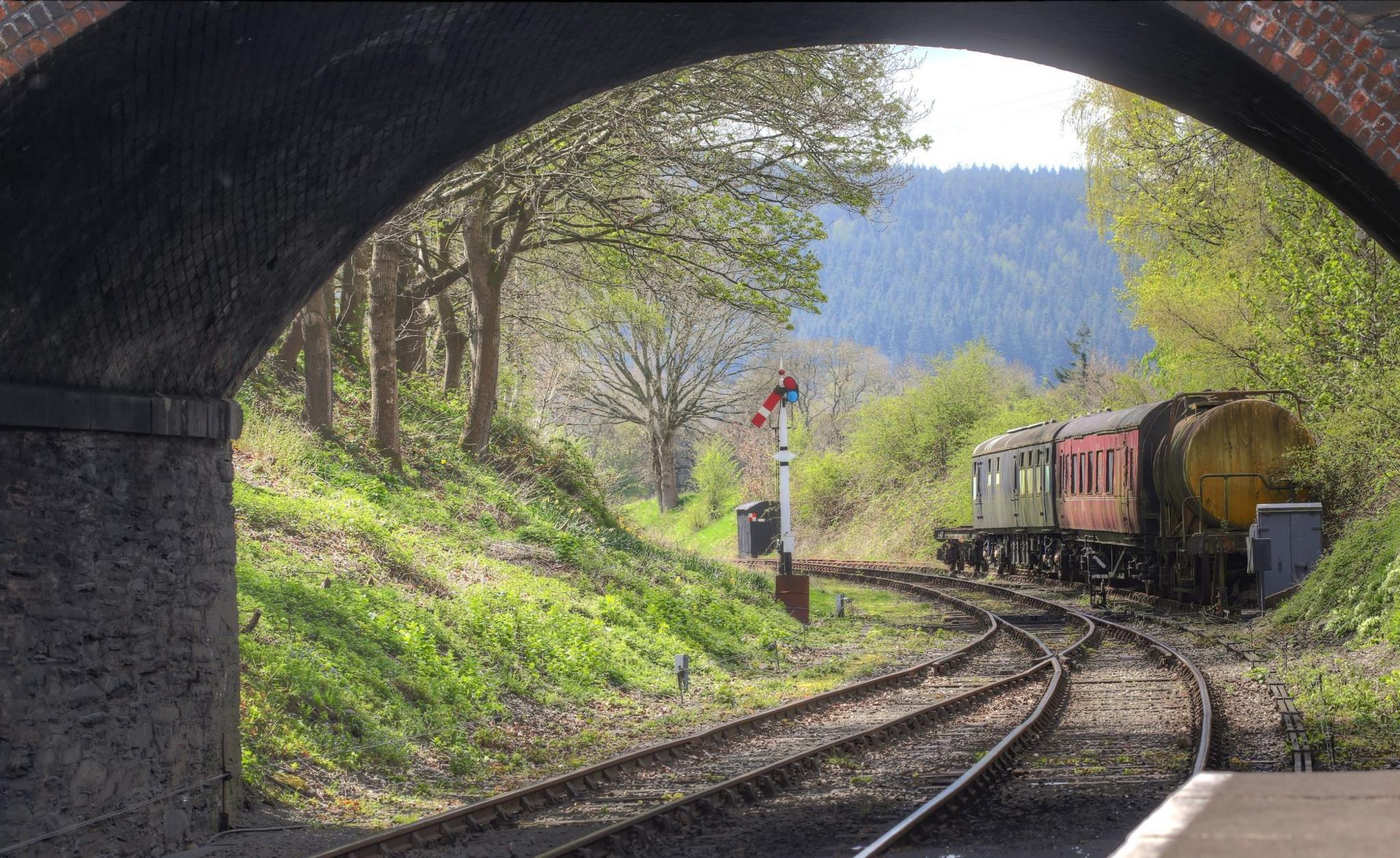 Railway carriages seen through the arch of a bridge