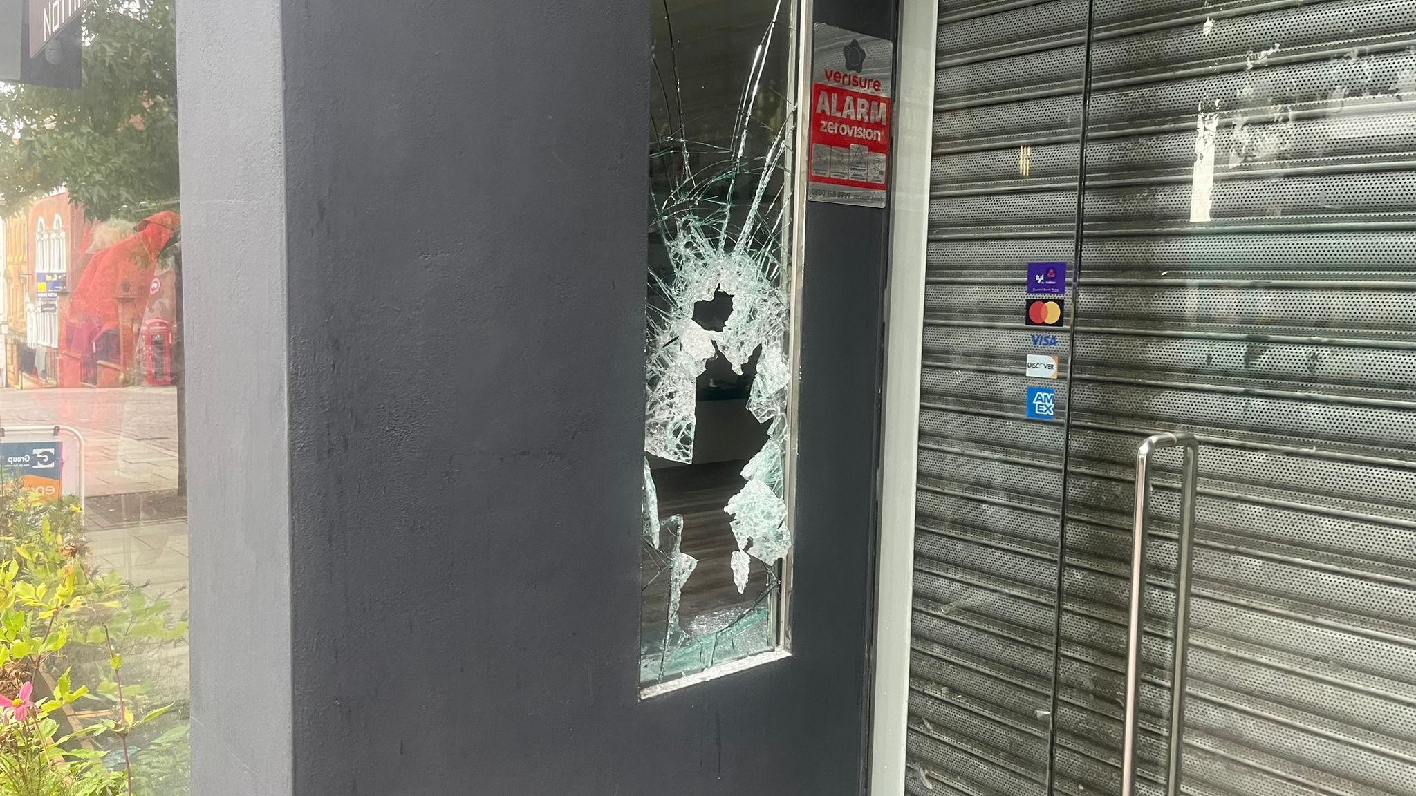 A smashed panel on the front windows of a shop