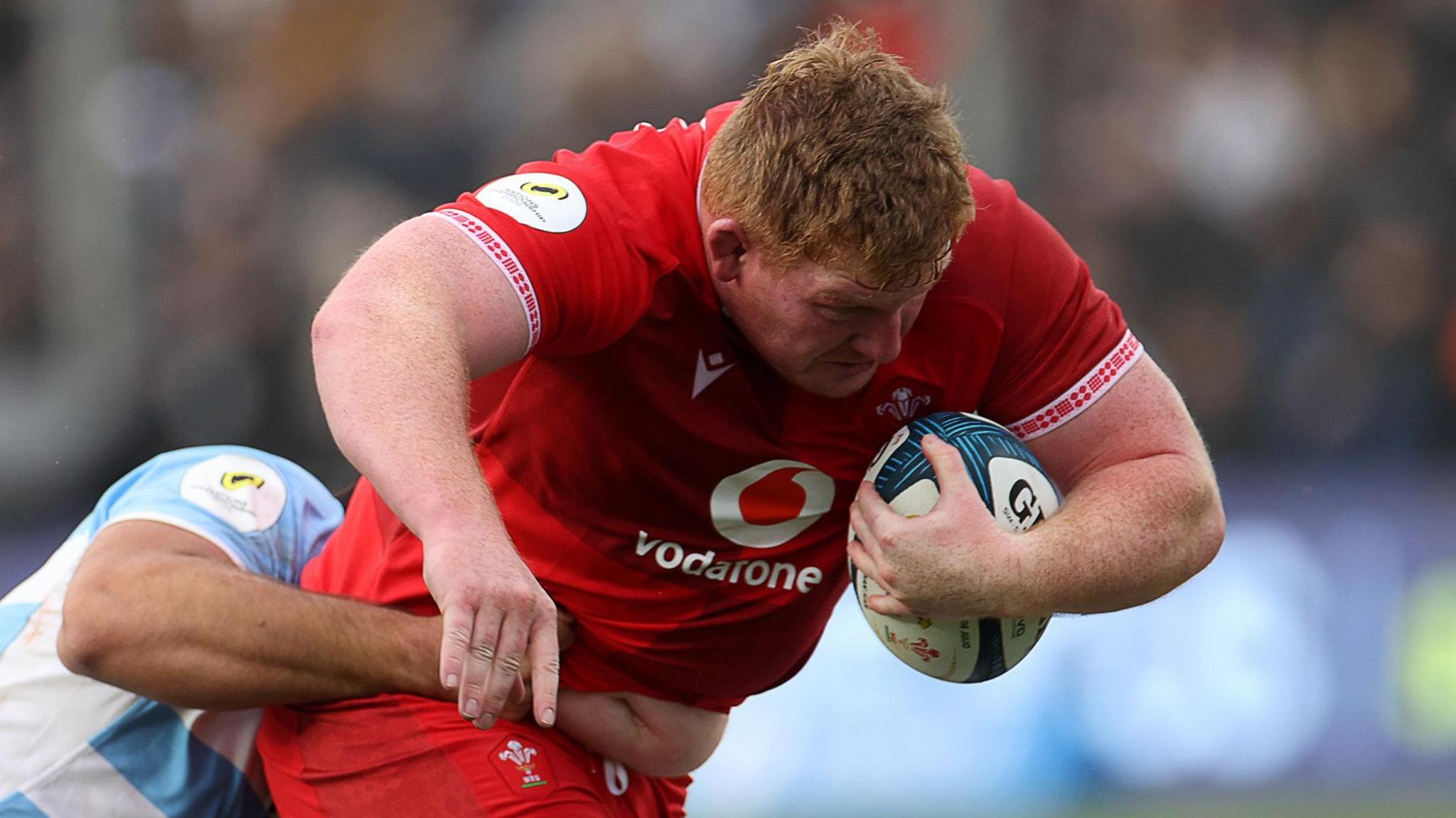 Prop Rhys Carre charges with the ball under his left arm when scoring a try for Wales in Argentina