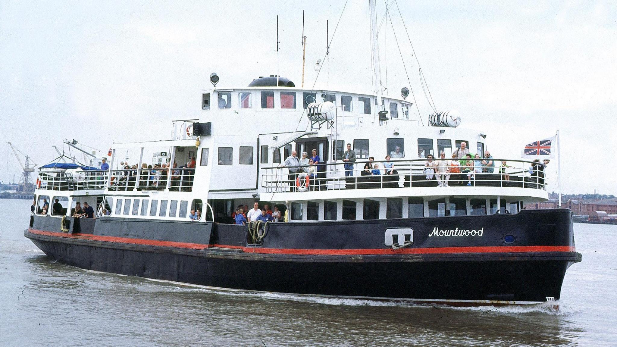 Mersey Ferry on the River Mersey with passengers onboard.