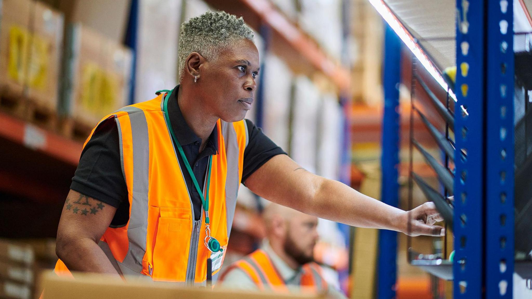 Warehouse worker in orange hi-viz jacket 