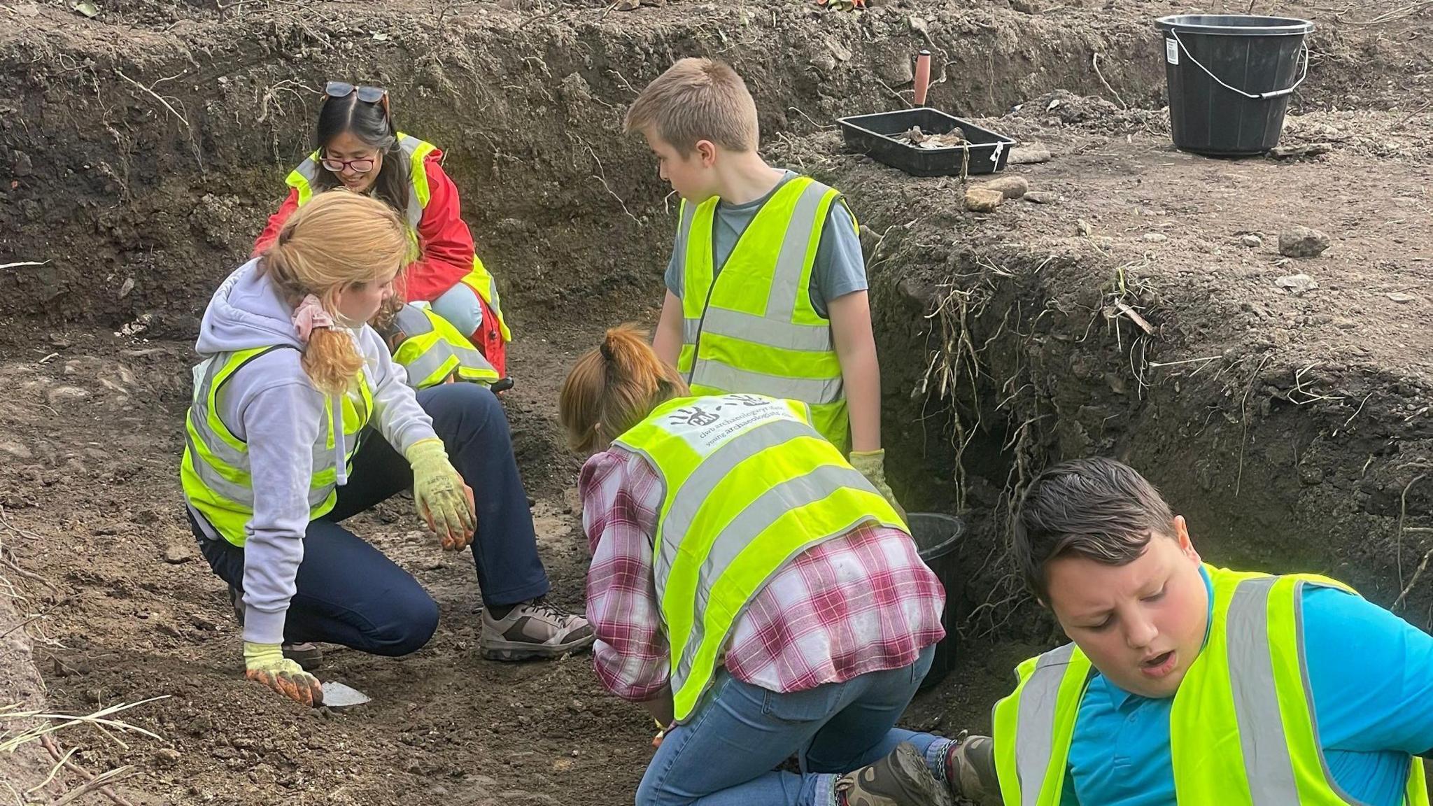 School pupils help excavate land to the west of Margam Abbey Church as part of the ArchaeoMargam project.