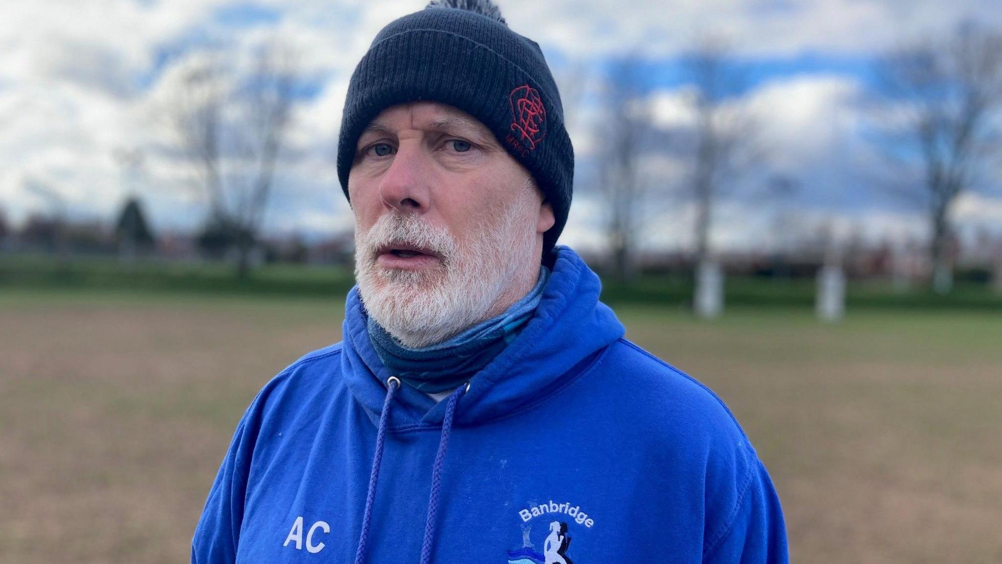 Aidan in a blue jumper and woolly hat