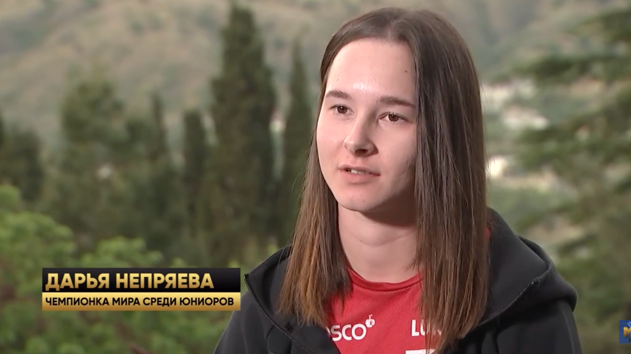 A screenshot of Dariya Nepryaeva being interview in Crimea for a TV report. Her name appears on the image as an aston