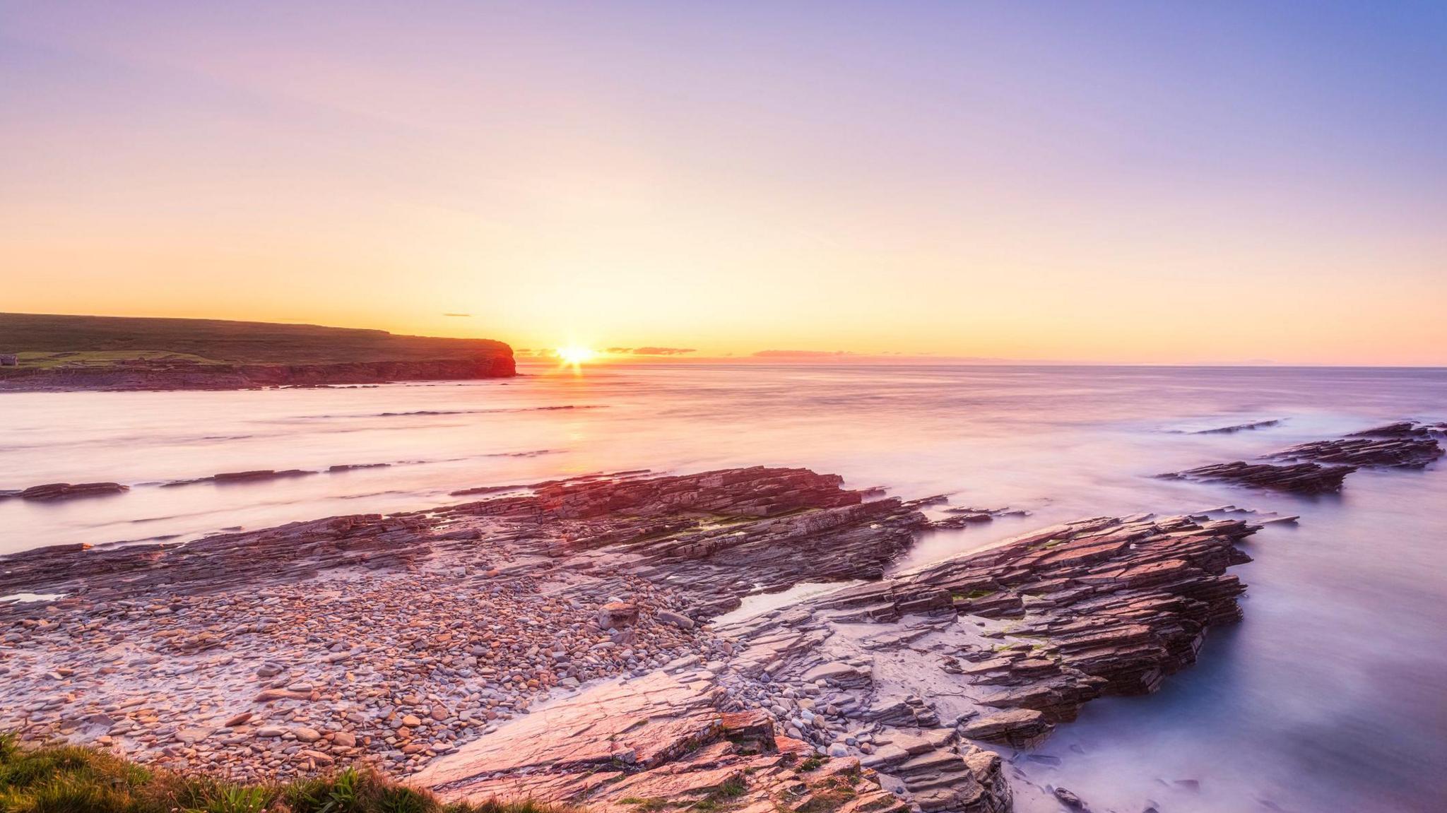 A sunset at the end of a glorious day over the Orkney Islands