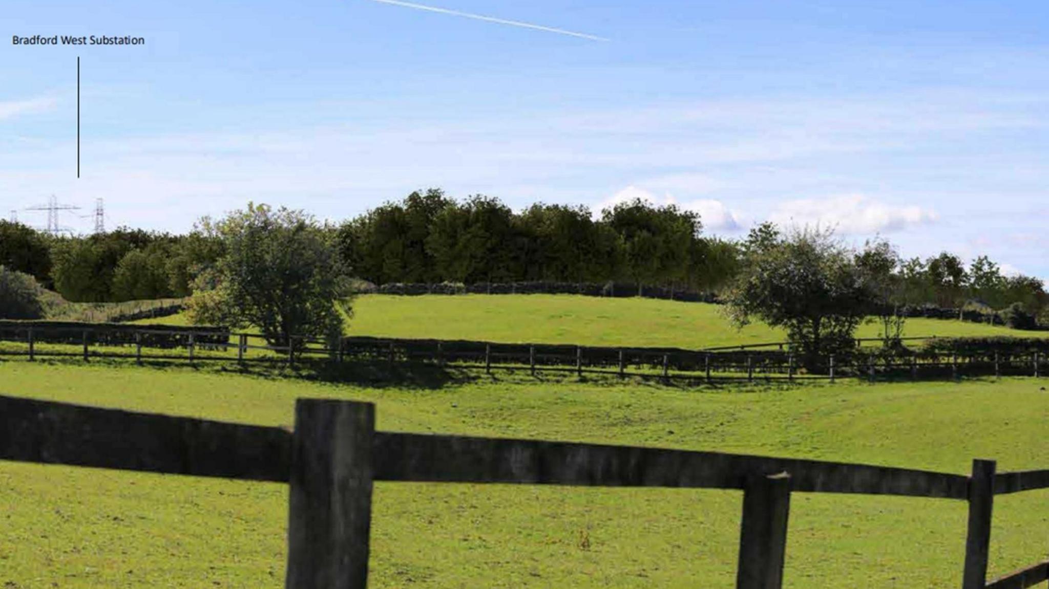 A series of green fields separated by wooden fences and dotted with trees. Behind the treeline an arrow points to the site of a substation, which is hidden by foliage.