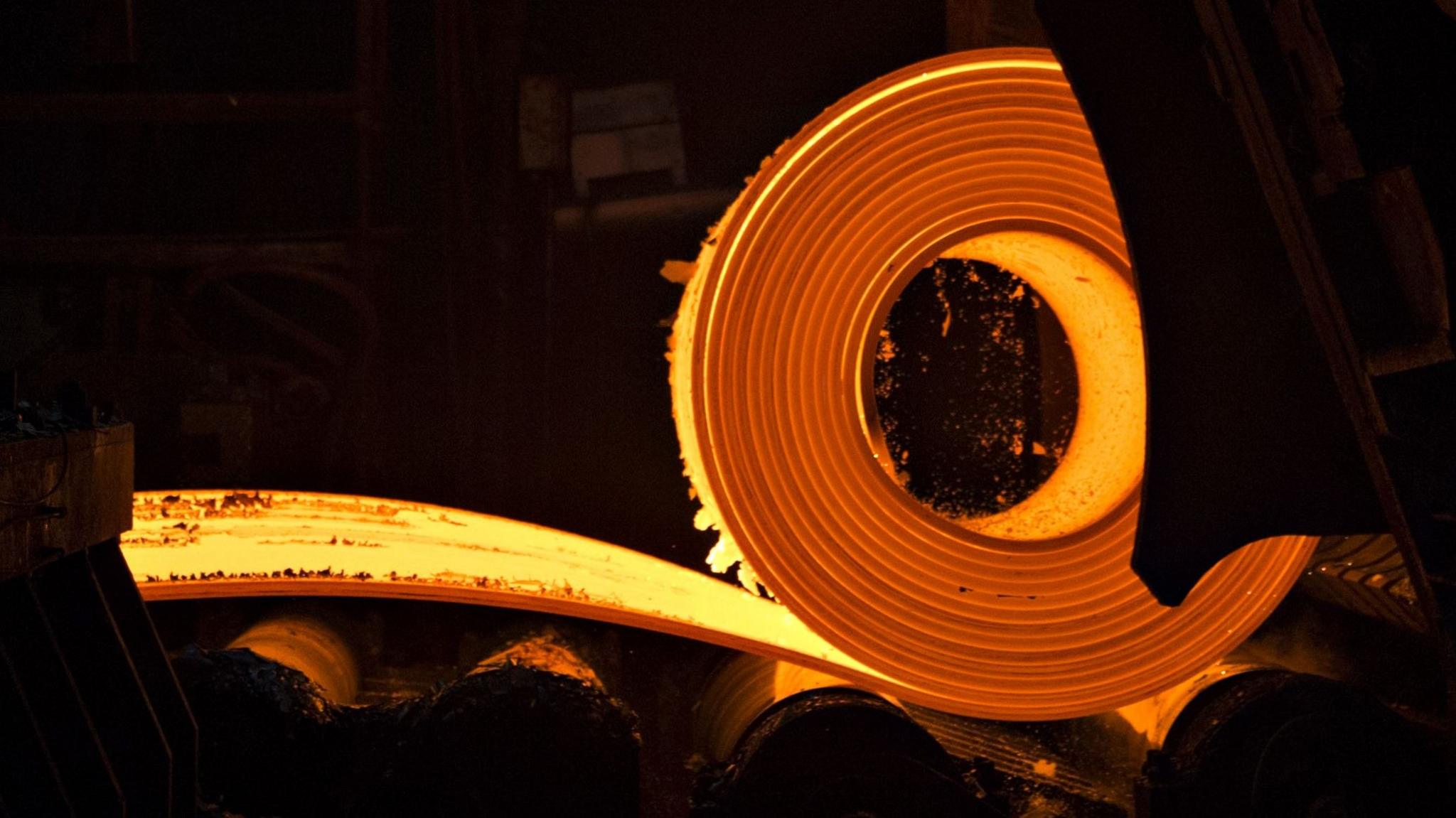 A roll of molten steel glows yellow and orange at a steel plant in Indiana.