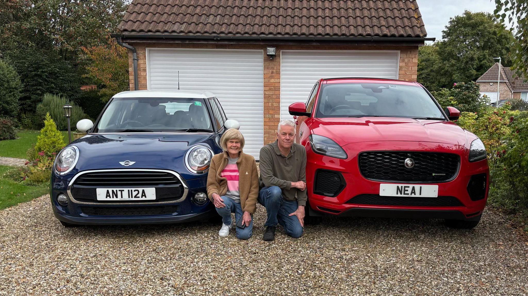 Neal Bircher next to an 'NEA 1' plate on his red car, and his mother Anthea who has an 'ANT 112A' plate on her blue  Mini