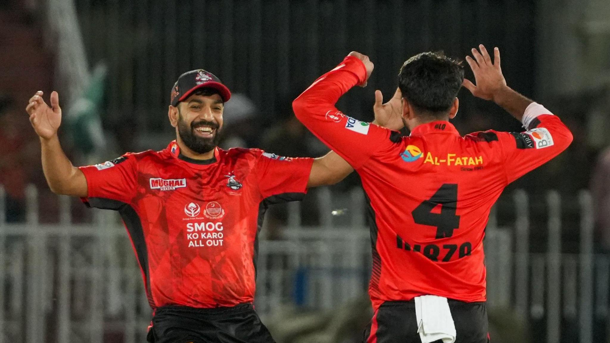 Two Lahore Qalanders players celebrate a wicket