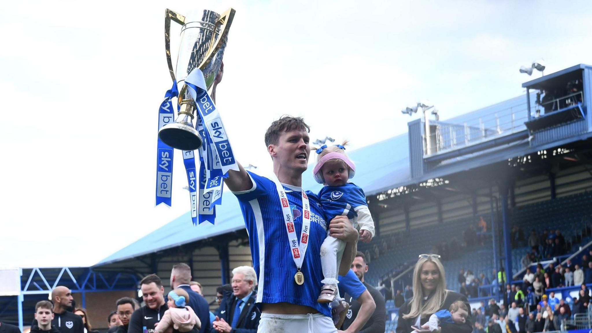 Sean Raggett celebrates lifting the League One title