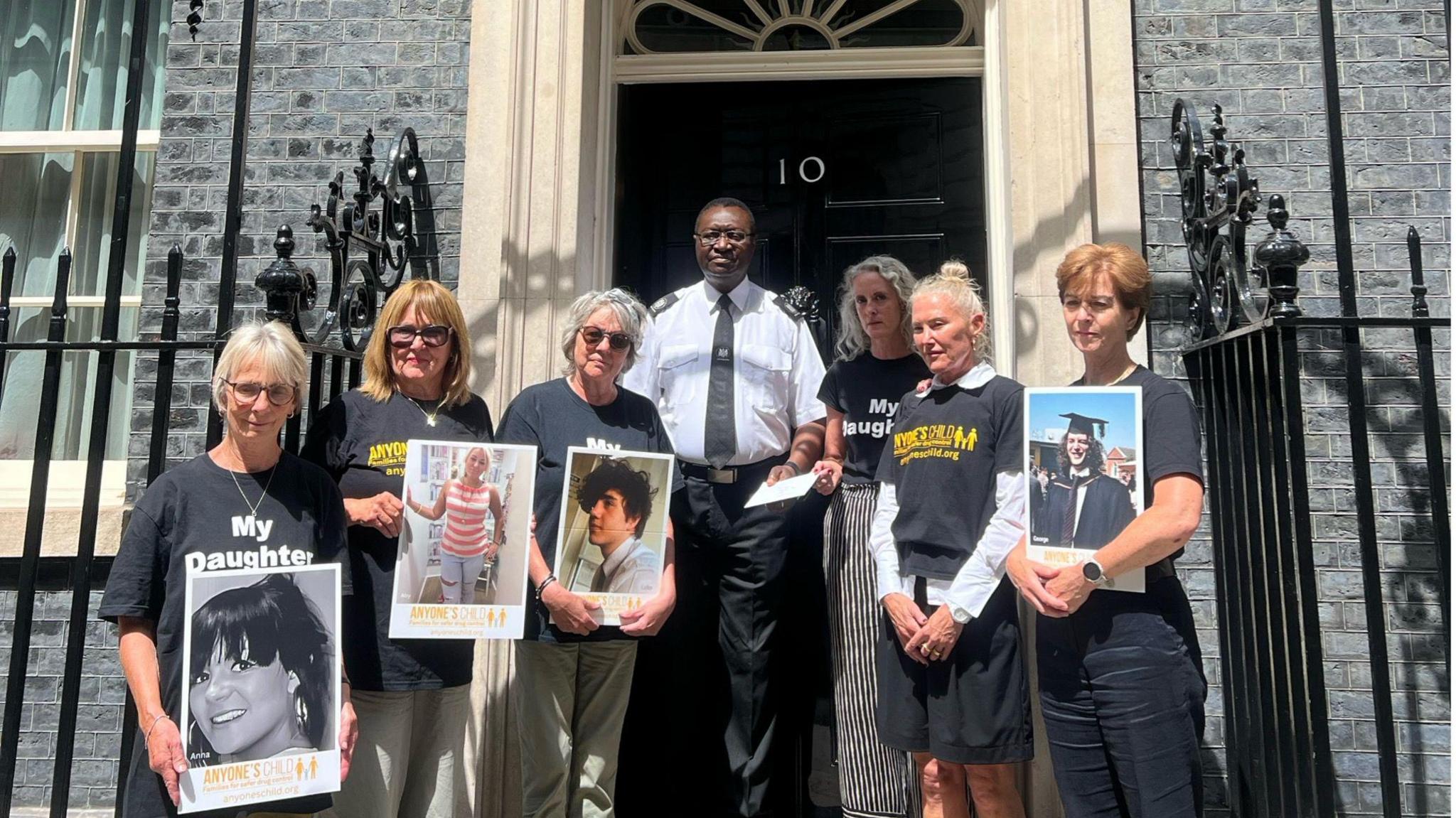 Six female campaigners who are part of the lobby group Anyone's Child. They are stood outside 10 downing street with a man who is collecting their letter.