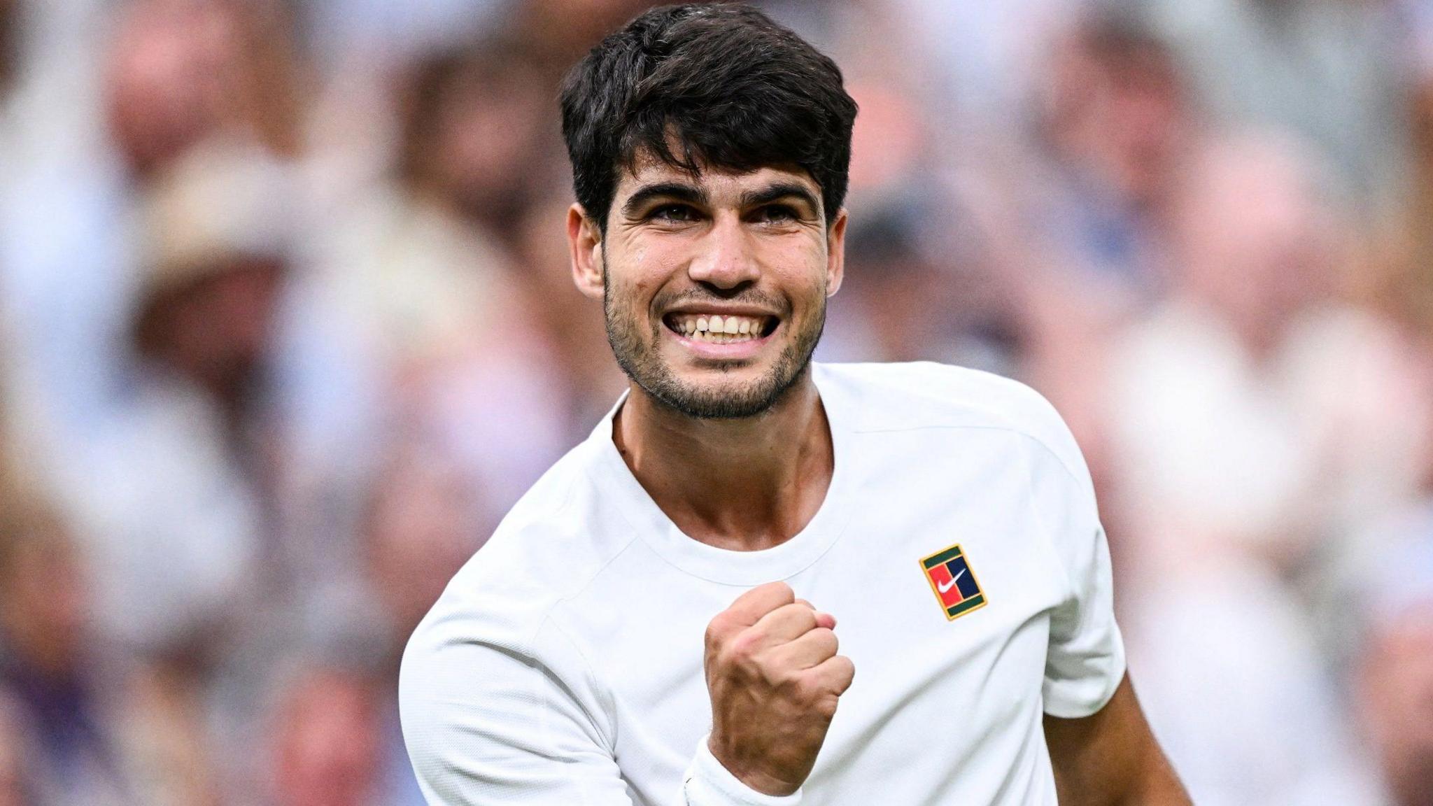 Carlos Alcaraz celebrates winning a point by clenching his fist