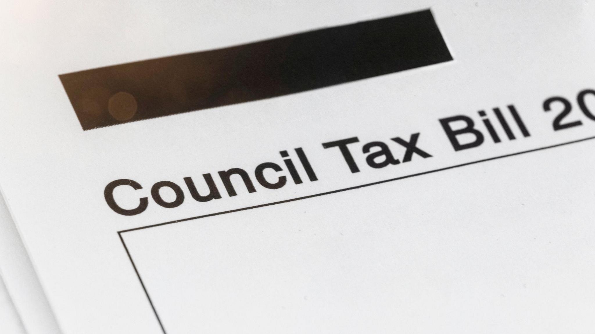 A close up photo of a piece of paper with "council tax bill" written on it.