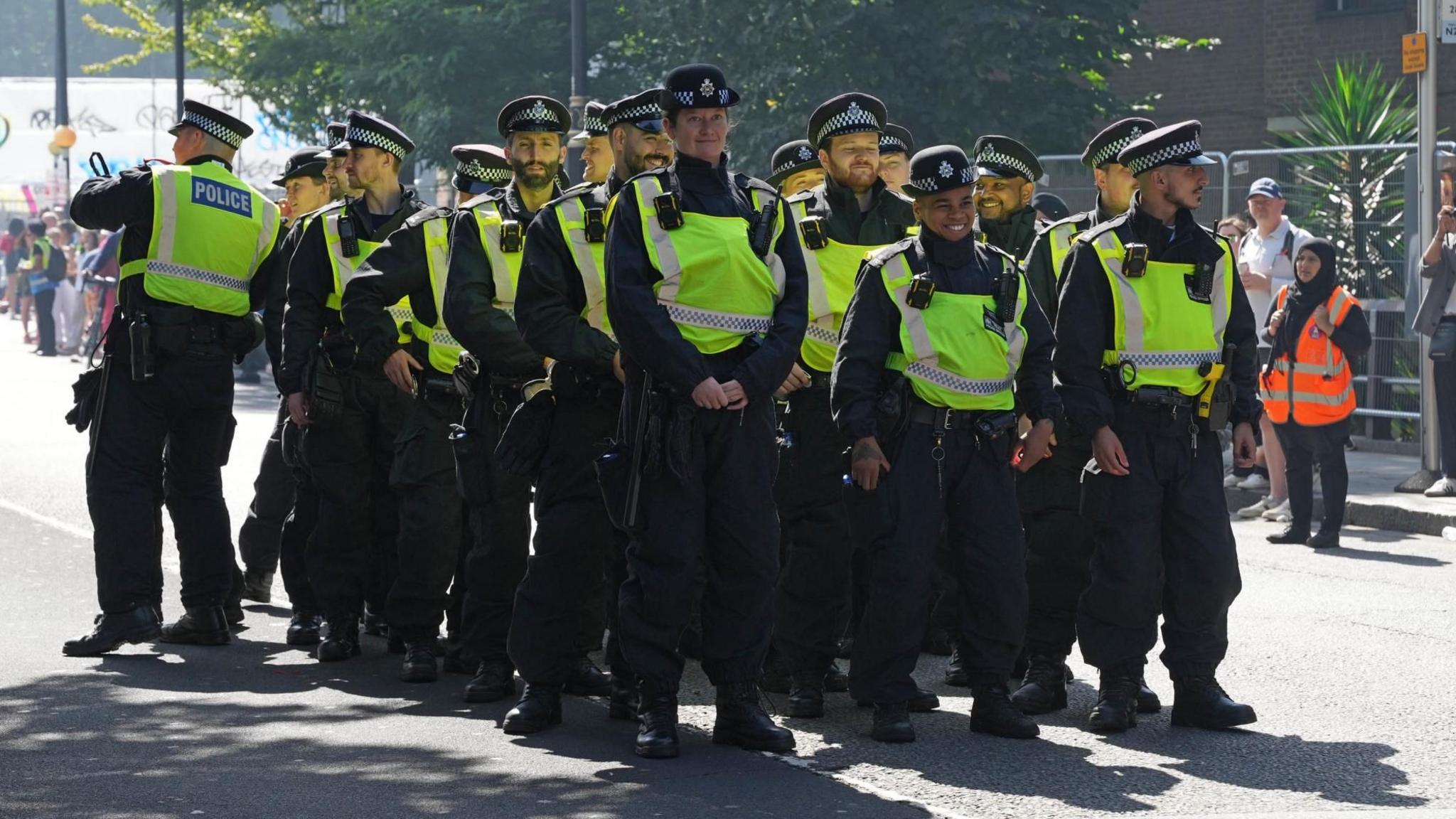 A group of police officers, some smiling, attend Notting Hill Carnival