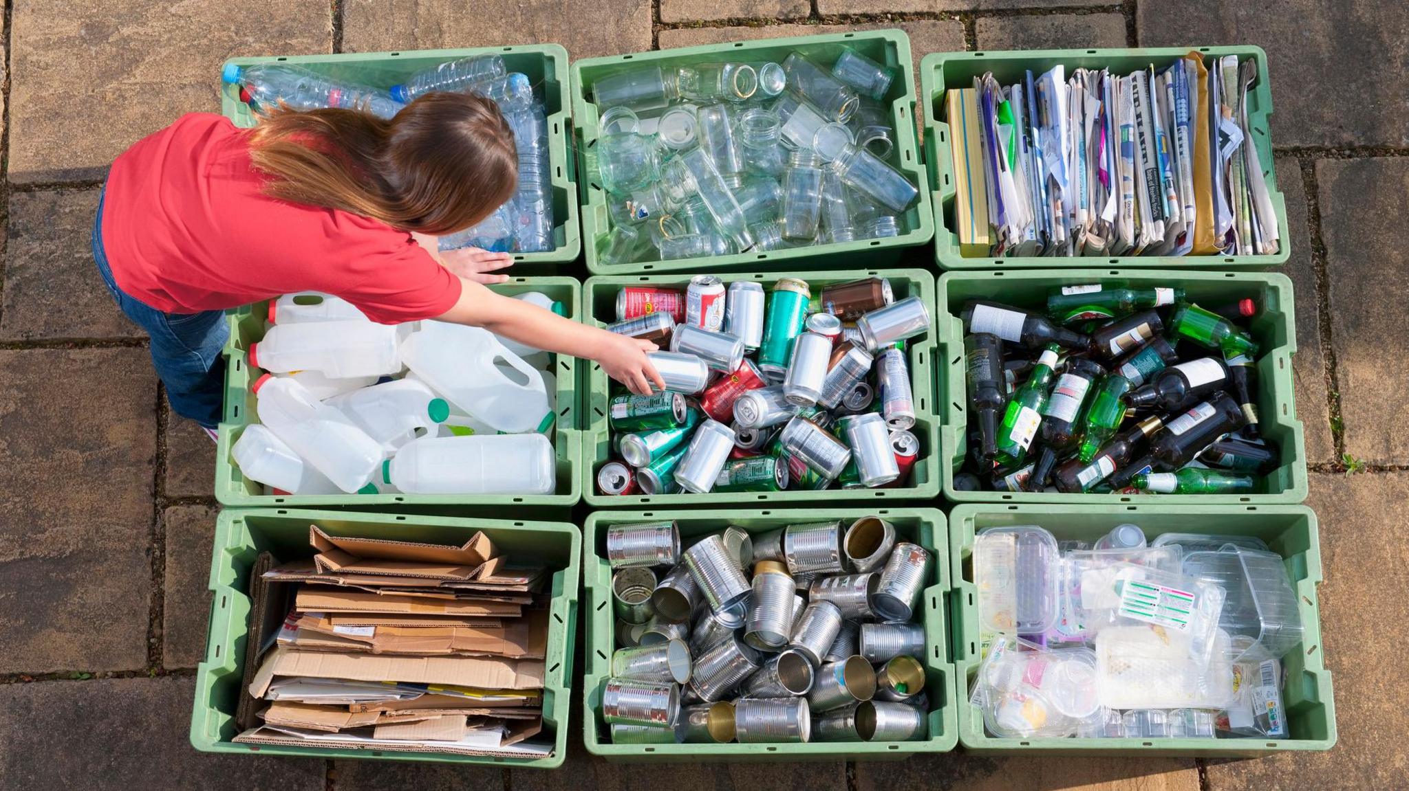 woman splitting up recycling