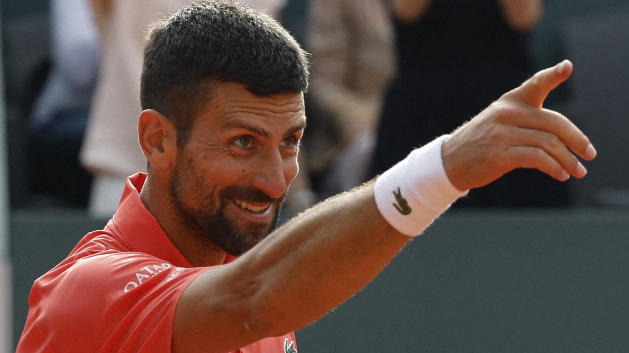 Novak Djokovic points to his family to celebrate his victory over Hubert Hurkacz at the Geneva Open