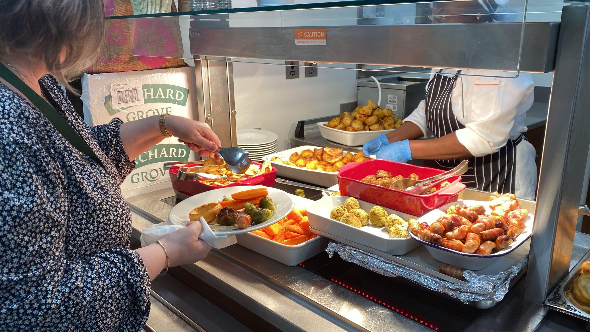 A buffet of the Christmas Dinner being plated up