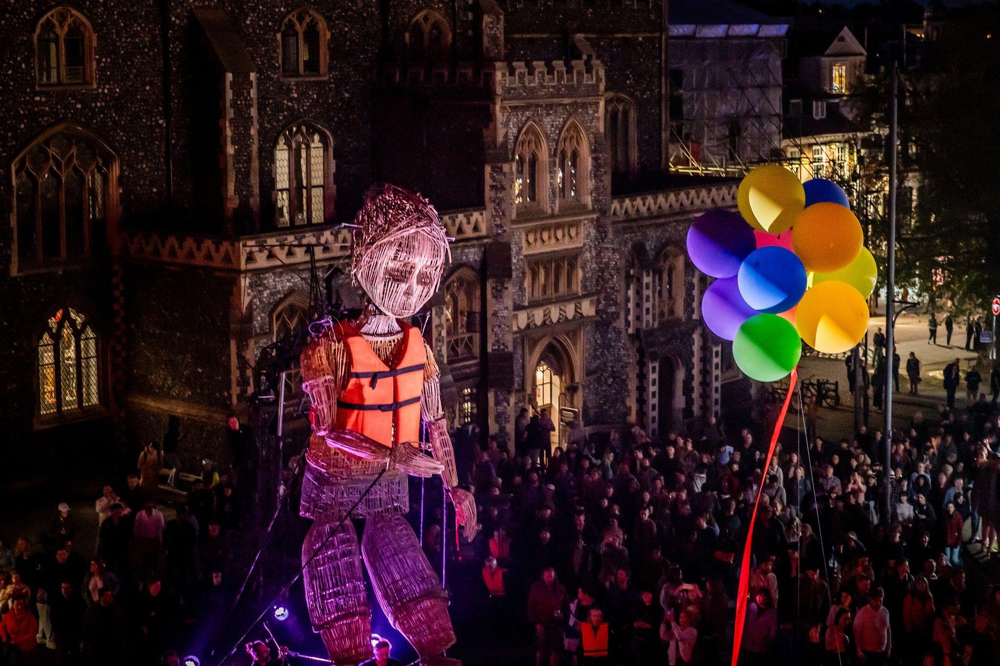 Giant puppet following balloons